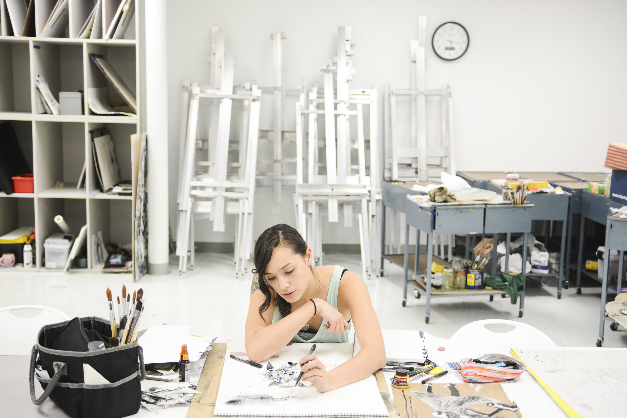 Junior Jennifer Wei fixates her attention on her abstract self-portrait at Moberly Area Community College’s studio. Wei's passions lie in helping children and doing art.