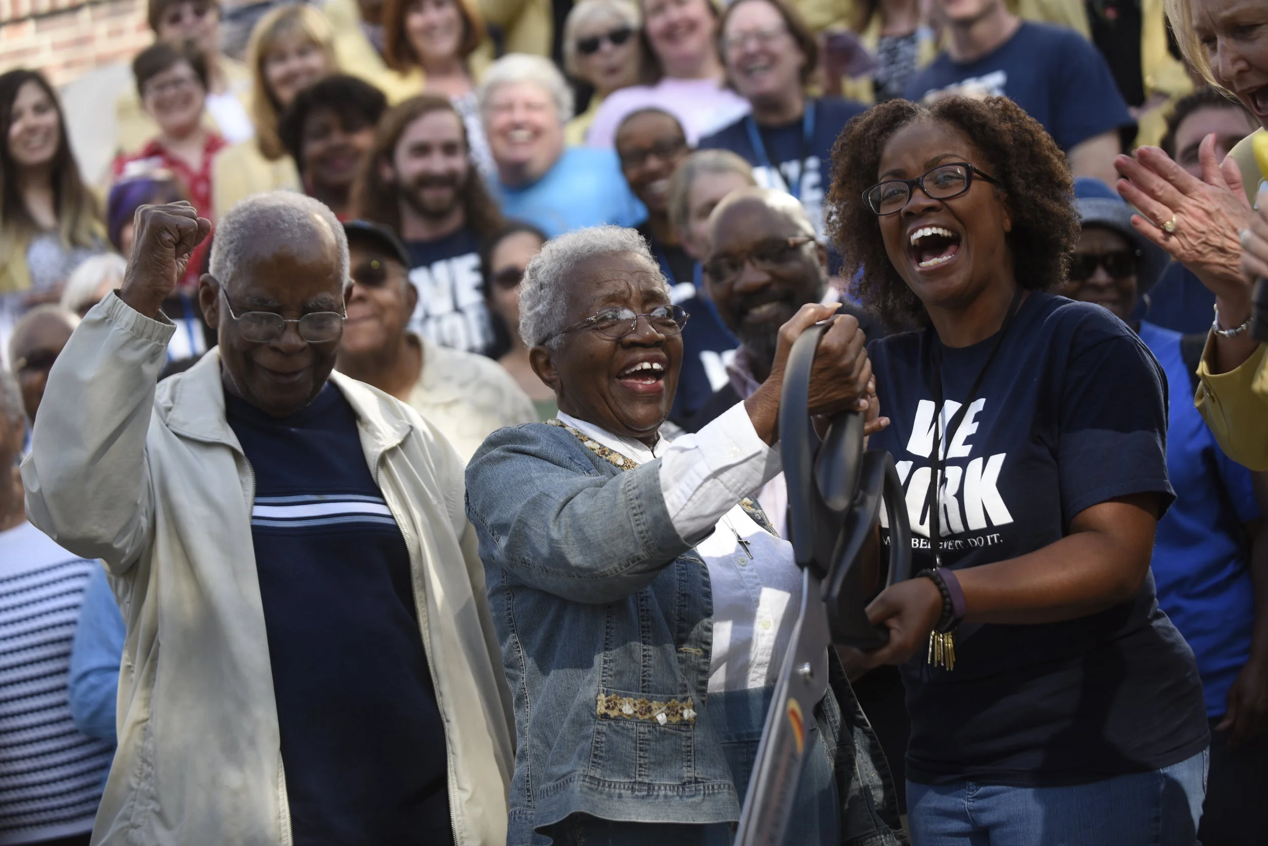  Mable Ballenger, Carl Ballenger and Eryca Neville(cq) rejoice after cutting the ribbon to reopen Douglass High School on Thursday, September 7, 2017. The Ballengers, husband and wife duo, graduated from Douglass High in 1955. Mable said one of her m