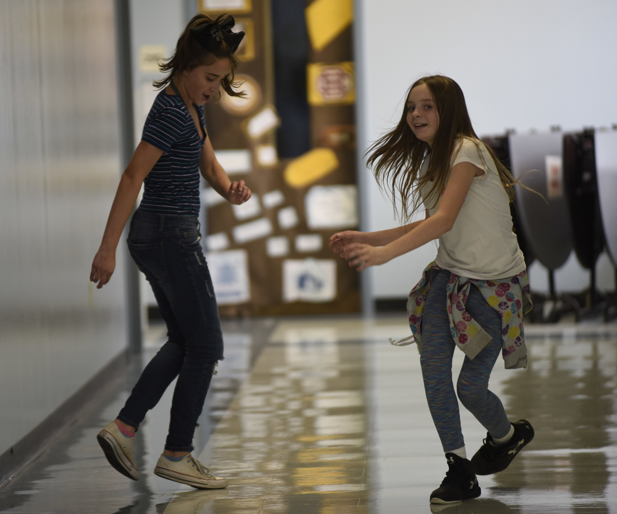Ansleigh Watson(cq), 12, left and Kadence Yaeger(cq), 11, right, run sideways down the hallway on Thursday, Oct. 5, 2017 at John B. Lange Middle School. The girls were paired into groups to learn how to watch out for one another as they go through e