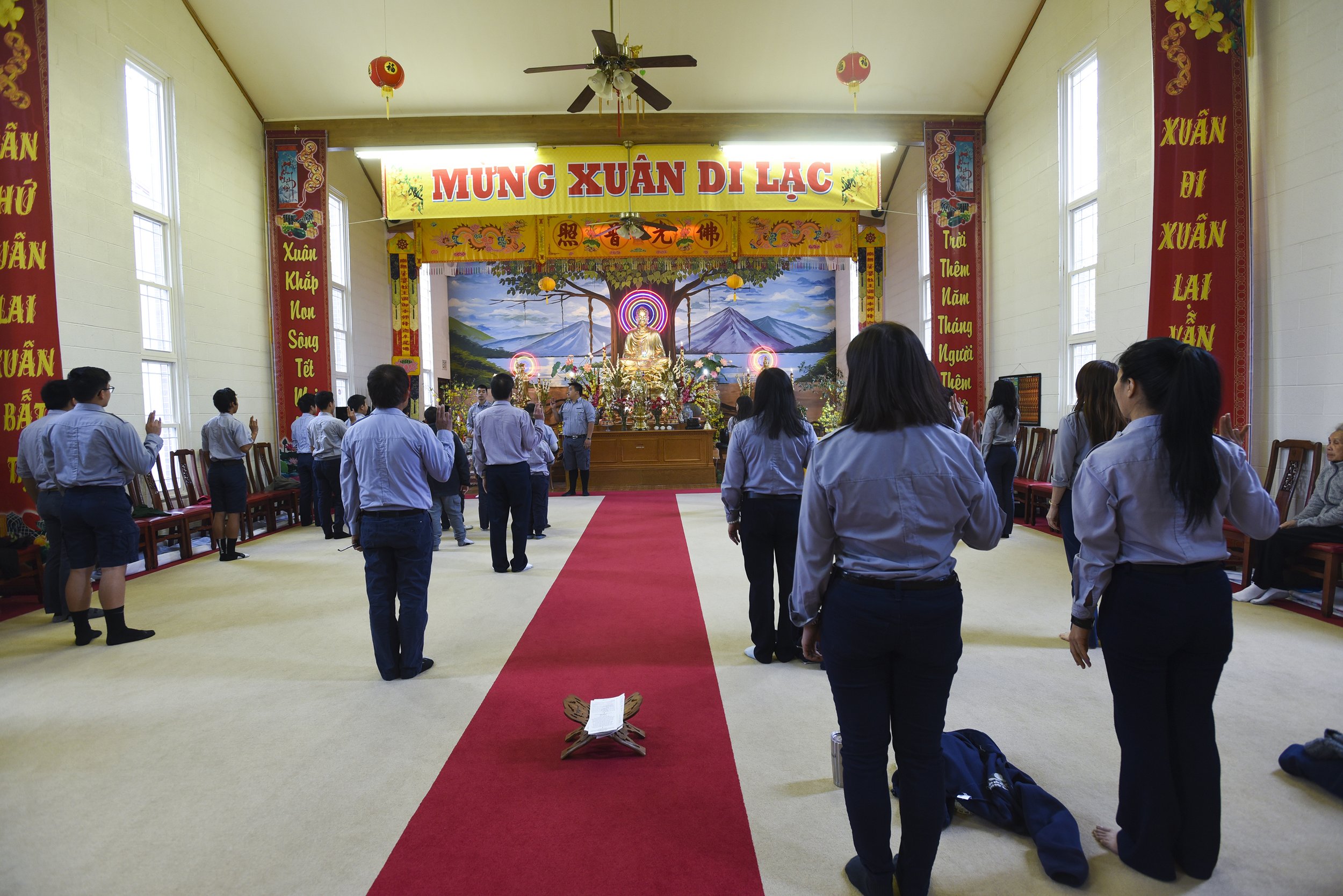 Gia Dinh Phat Tu Pho Hien (Pho Hien Buddhist Youth Association) salutes the association's flag on April 15, 2018 at Pho Hien Buddhist Temple in Kansas City, Missouri. After saluting, the entire association sings the international Buddhist associatio