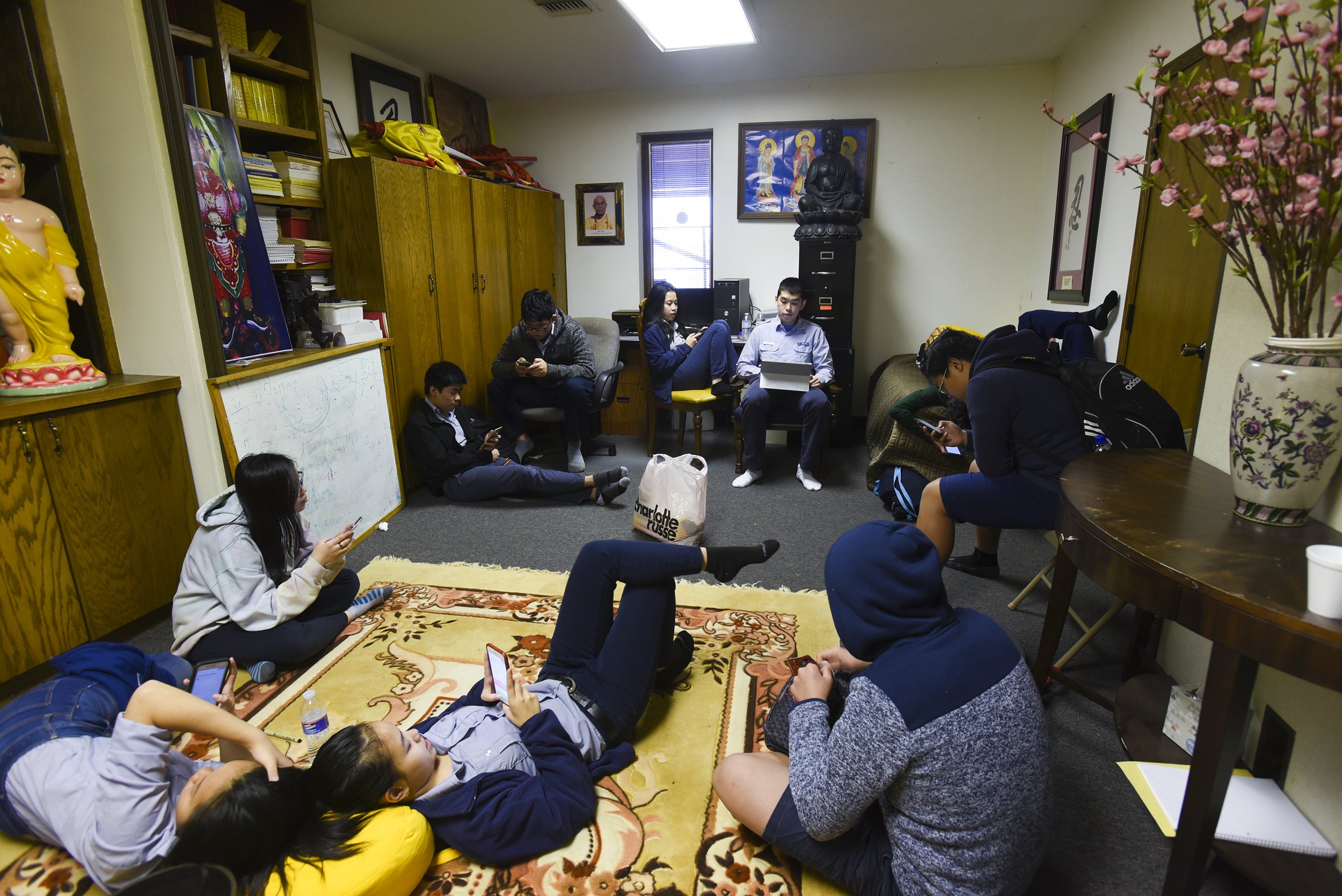 Pho Hien Buddhist Association's upper-level Vietnamese class works on building a higher score with the mobile language learning applicaiton Duolingo on April 15, 2018 at Pho Hien Buddhist Temple in Kansas City, Missouri. The association used Duoling
