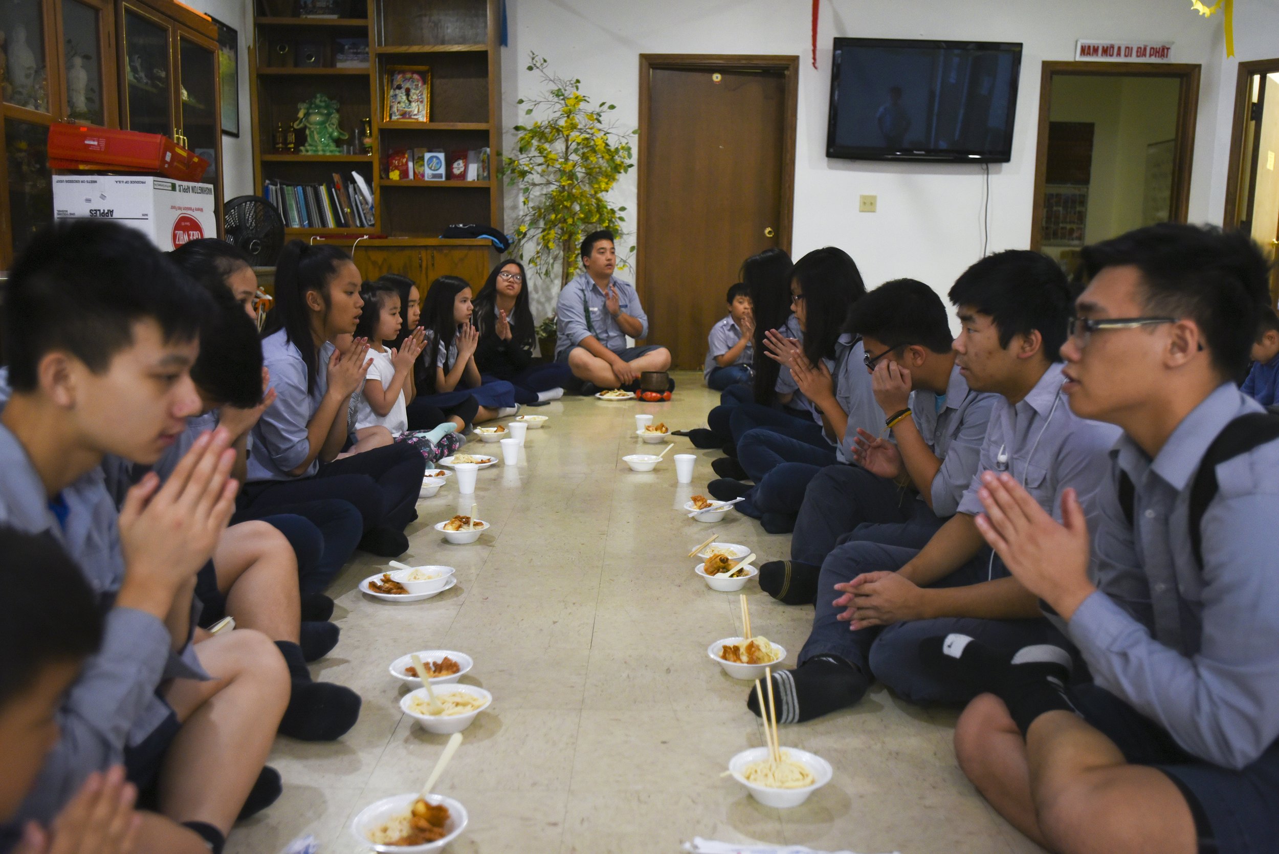 Members pause to pray before eating lunch on April 29, 2018 at Pho Hien Buddhist Temple in Kansas City, Missouri. Before eating lunch on Sundays, members would pray, and then, eat mindfully in silence for five minutes before talking to one another.