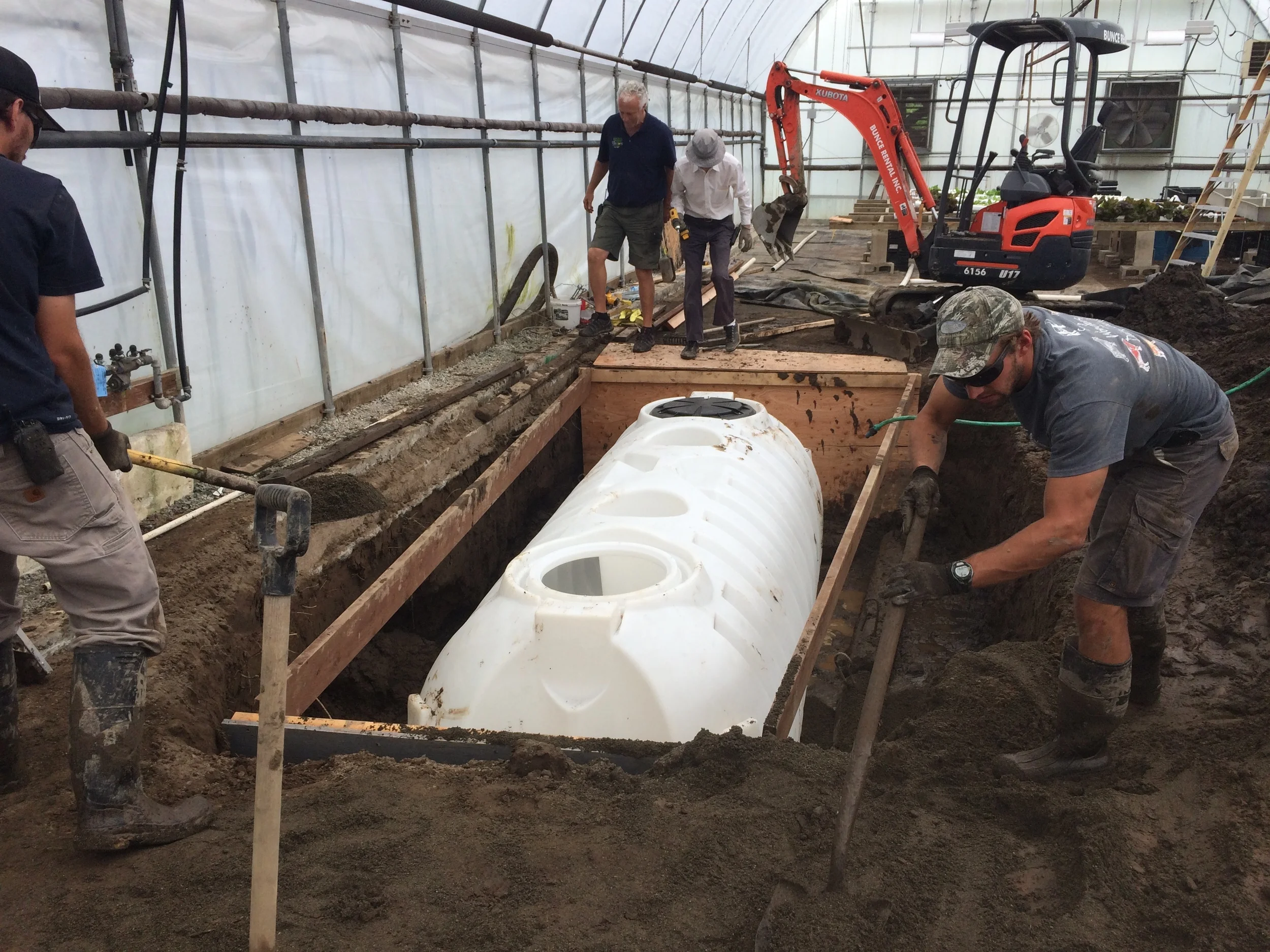 Above you can see the depth and plywood we had to put up in order to save from soil collapsing. Next was securing the tank to concrete + rebar. The water went up almost halfway the next day!