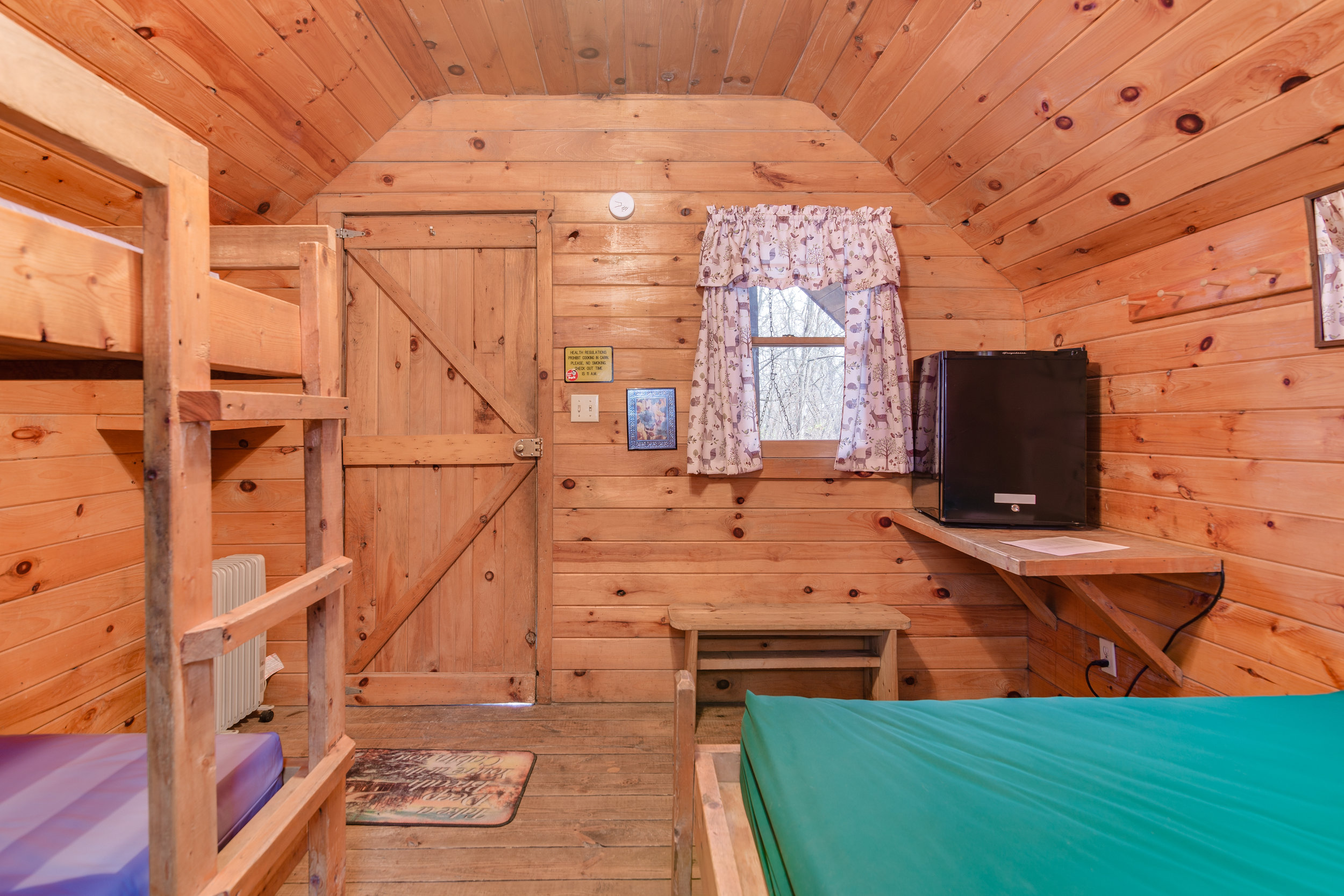 Twin bunks, full size bed, and small refrigerator in K3