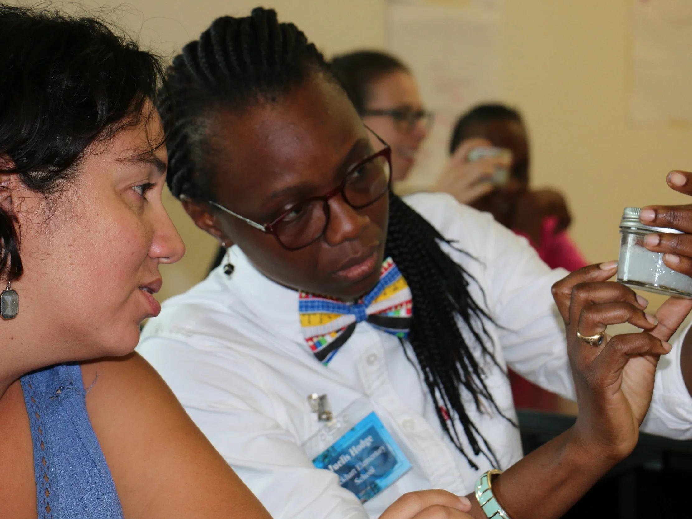 Participants at a marine debris workshop get a close up look at microplastics.