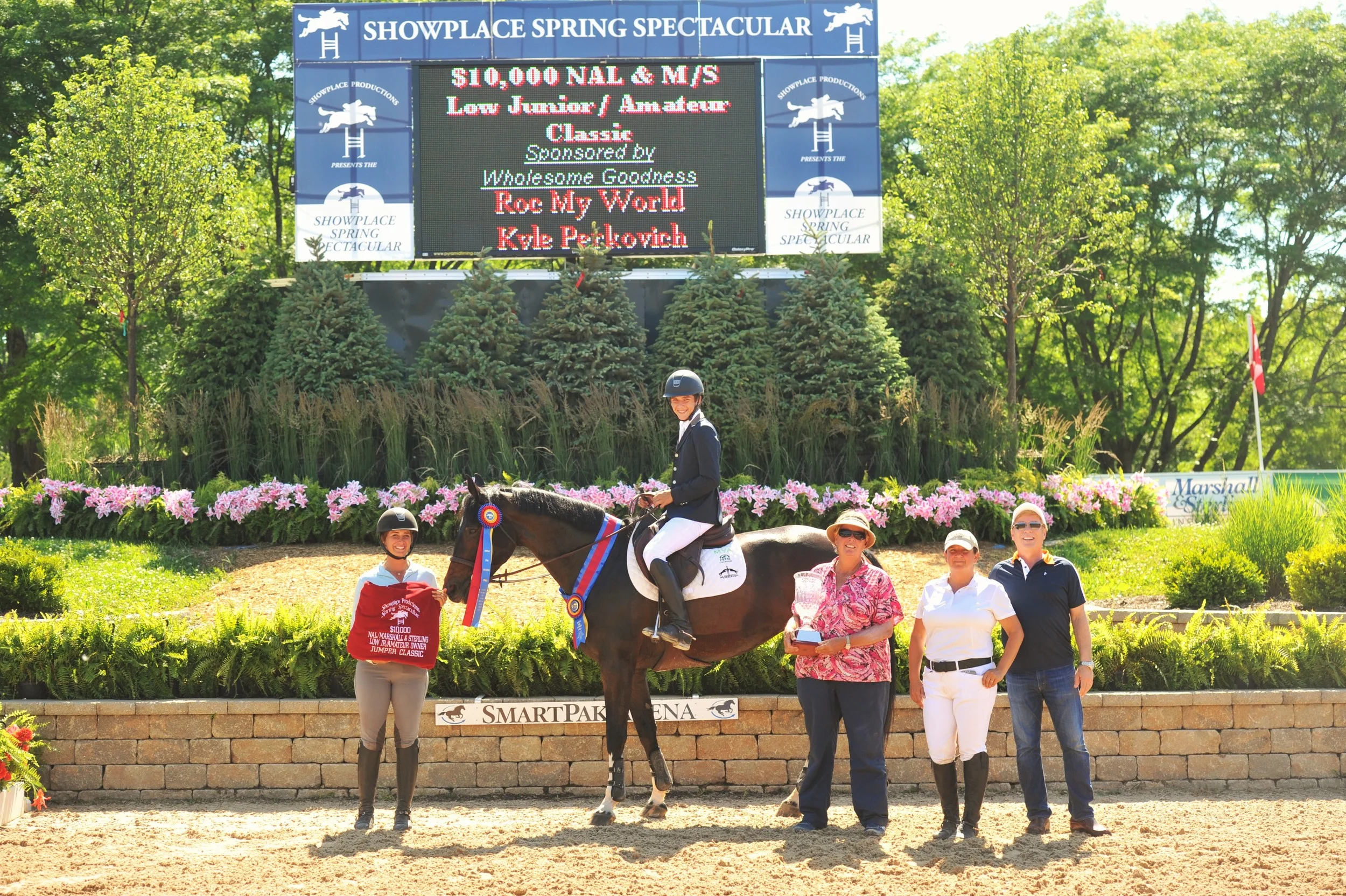 Trainers Lisa and Mary Goldman With Perkovich and his parents, Brenda and Rick. Photo by Andrew Ryback Photography