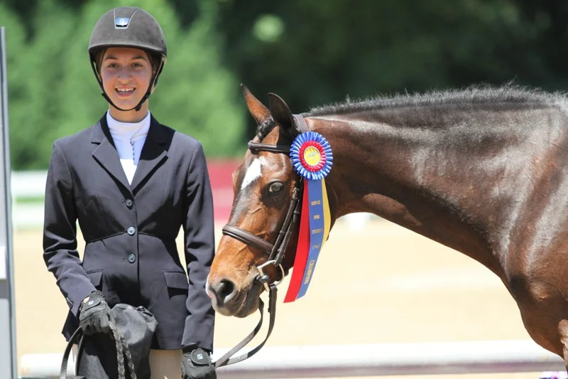 Madeline Pogorzelski Large Pony Hunter Champion With Madeline Pogorzelski aboard, Hillcrest Songbird took first in the Large Pony Hunter division. “Eva,” is owned by Canterbury Farm. “This is my second week showing her,” Pogorzelski said. When riding to the jumps, she said she has to focus on the landings. “I have to make sure she lands on the right leads.” Though the pair have had a successful week and Eva is described as nice, Pogorzelski said the pony can be a little “bratty.” “… She’s a pony,” she laughed.
