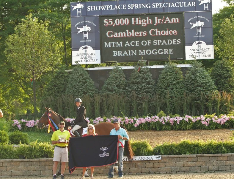 $5000 High Junior/Amateur Owner Gamblers Choice, sponsored by the Dollins Group 14-year-old Brian Moggre claims the top two places in the High Junior/Amateur Jumpers, this time in the Gambler’s Choice with MTM Ace of Spades with the blue and MTM Flutterby in second. Both horses are owned by Major Wager LLC. 