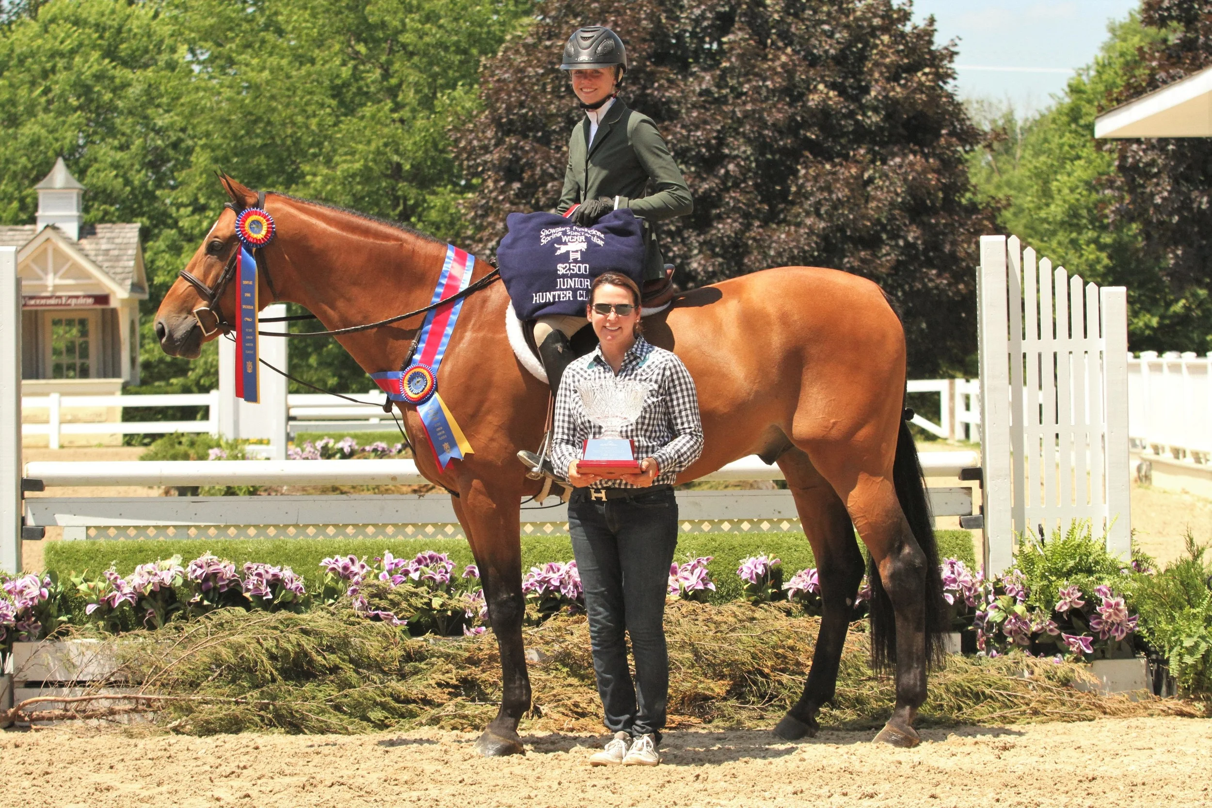 Justified and Paige Matthies, with trainer Melissa Hirt $2,500 Junior Hunter Classic sponsored by the Stoeckle Family Large Junior Hunter 15 & Under Champion Justified, owned by Dudley B Smith and ridden by Paige Matthies, championed the Large Junior Hunter 15 & Under division and the Junior Hunter Classic. “He’s a really fun horse. He’s very sweet and kind. He always wants to do his best for you, if I make a mistake, he’s always there to help me out,” Matthies said. “Mostly today, since it’s so hot, he was a little tired, so I had to focus on keeping him in front of my leg. But, the course was designed very well, it was really easy to have options. You had options on the course, the distances for turns, but it was more of a choice to the rider depending on the horse.” Regarding the Showplace Productions shows, Matthies said, “It’s such a great show. All the events are great. The jumps are beautiful and everything is designed really well. It’s one of my favorite shows.”