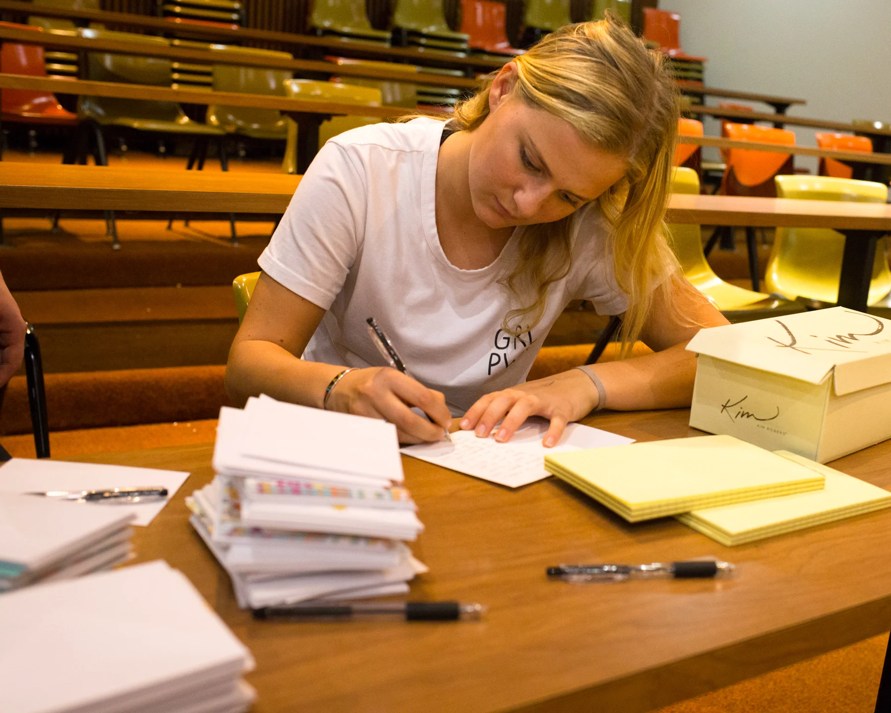 A student writes notes to soldiers. Photos by Rooney Coffman