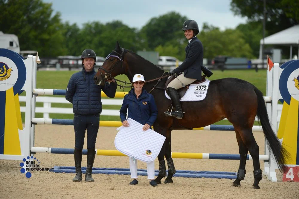 Cynthia Hampton from Classic Champions, Inc.presents the award for the champion of the 7-Year-Old Young Jumpers Maui SCF ridden by Jennifer Waxman. Photo by Anne Gittins Photography