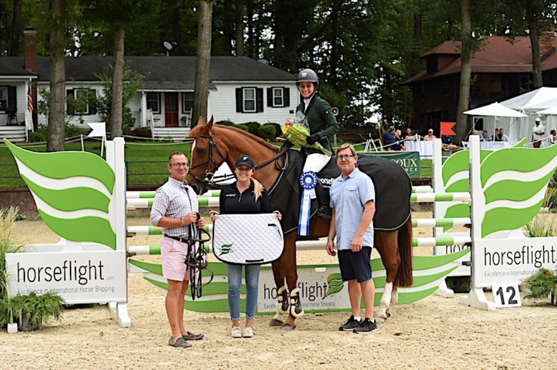 Co-owners Michael Dowling and Tucker Ericson along with Kaylee Donahue from Redfield Show Tack presented the award to Sima Morgello who won the $10,000 Mini Prix, sponsored by Horseflight, at Monmouth at the Team in 2018. Photo by Anne Gittins Photography
