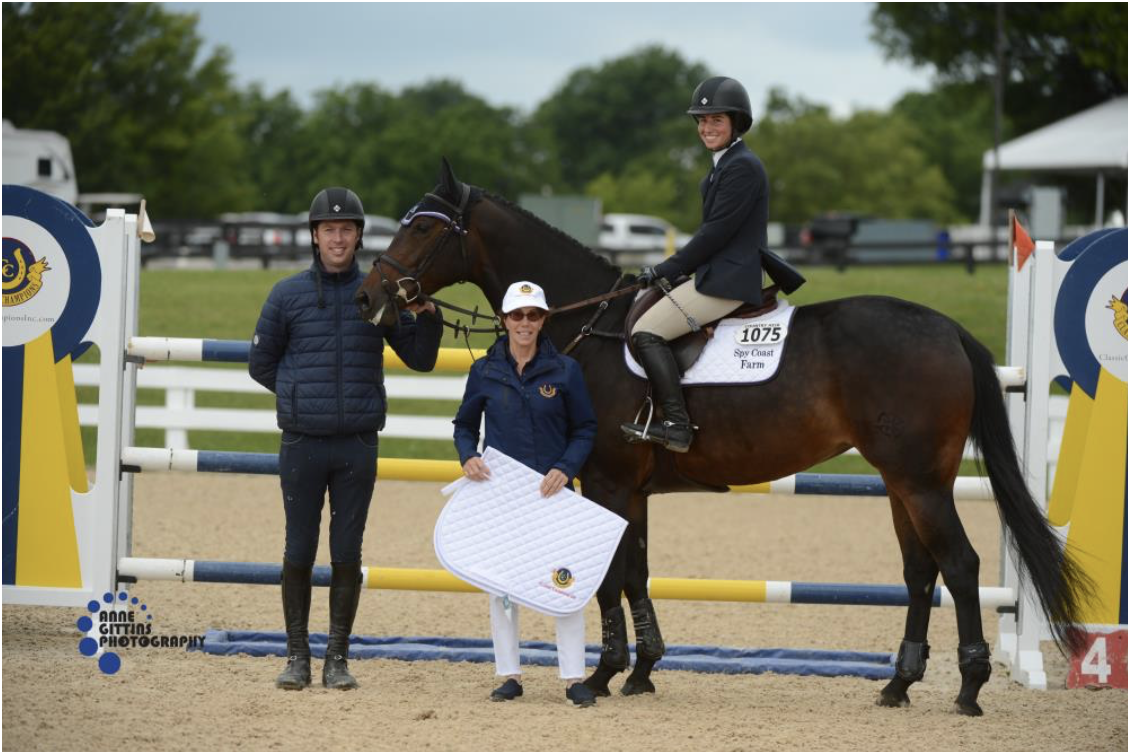 Cynthia Hampton from Classic Champions, Inc.presents the award for the champion of the 7-Year-Old Young Jumpers Maui SCF ridden by Jennifer Waxman. Photo by Anne Gittins Photography