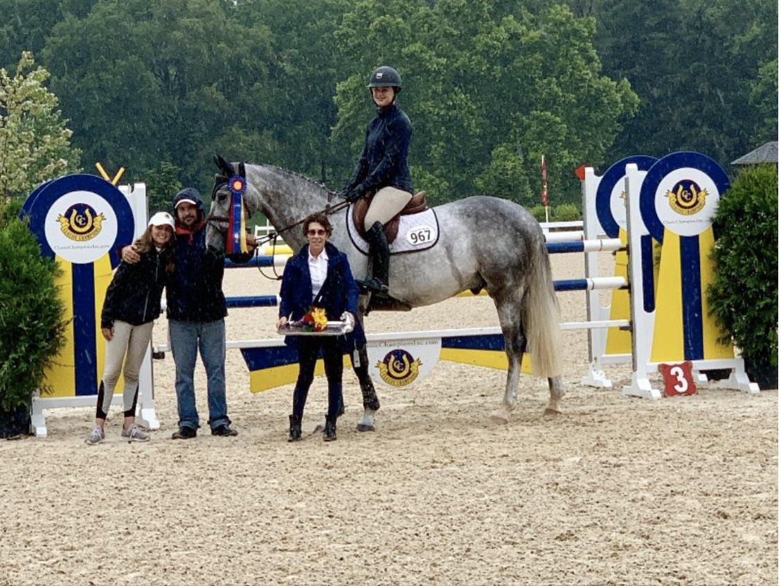 Cynthia Hampton presents the award to Hayley Barnhill and Country Heir Week I 7-Year-Old Young Jumper Champion Higuain. Photo by Anne Gittins Photography