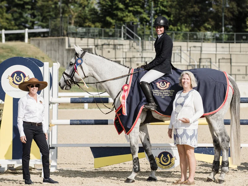 Cynthia Hampton presenting the champion ribbon and Classic Champions Award of Distinction to Jennifer Waxman and Out Of The Blue SCF owned by Lisa Lourie for the 5-year-old division. Photo By EQ Media