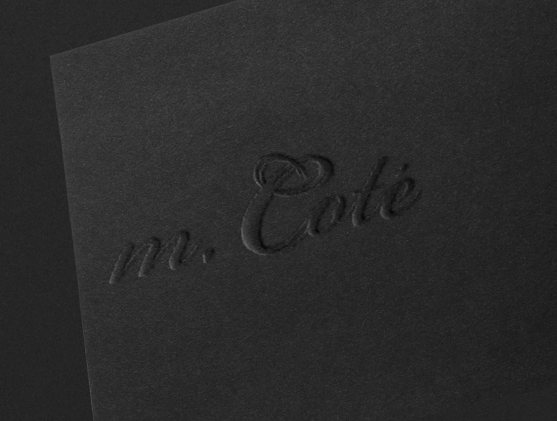 mcote black embossed logo.jpg