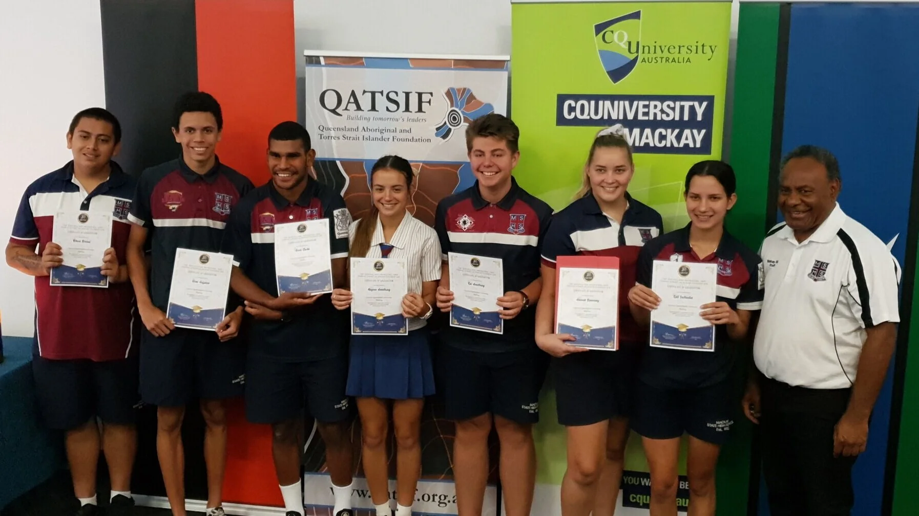 Students from Mackay State High School proudly showing off their graduation certificates.