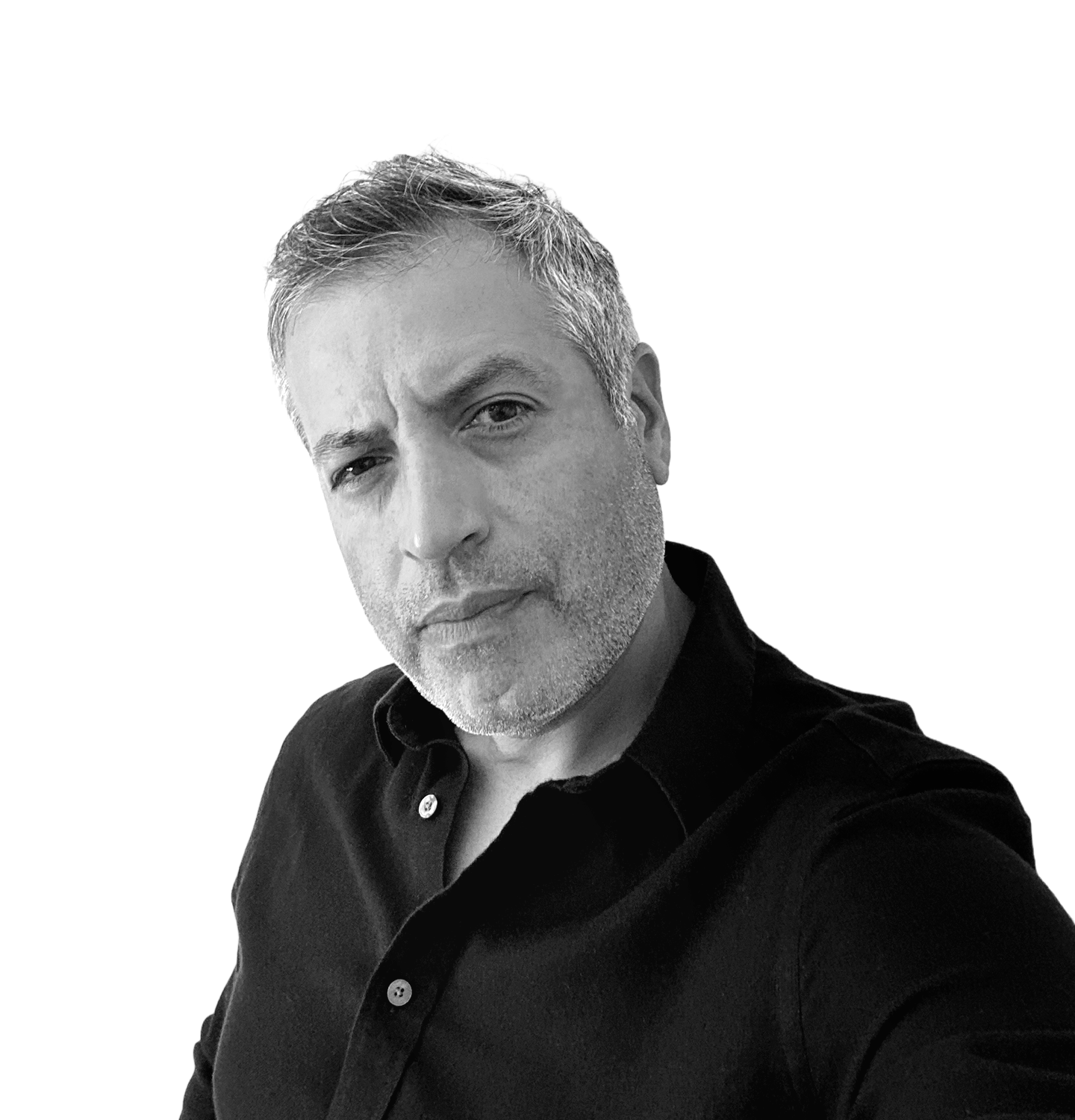 A black and white photo of a man with short, gray hair and a trimmed beard, wearing a black collared shirt with the top button undone, looking directly at the camera with a serious expression against a background with black, white, and gray horizontal stripes.
