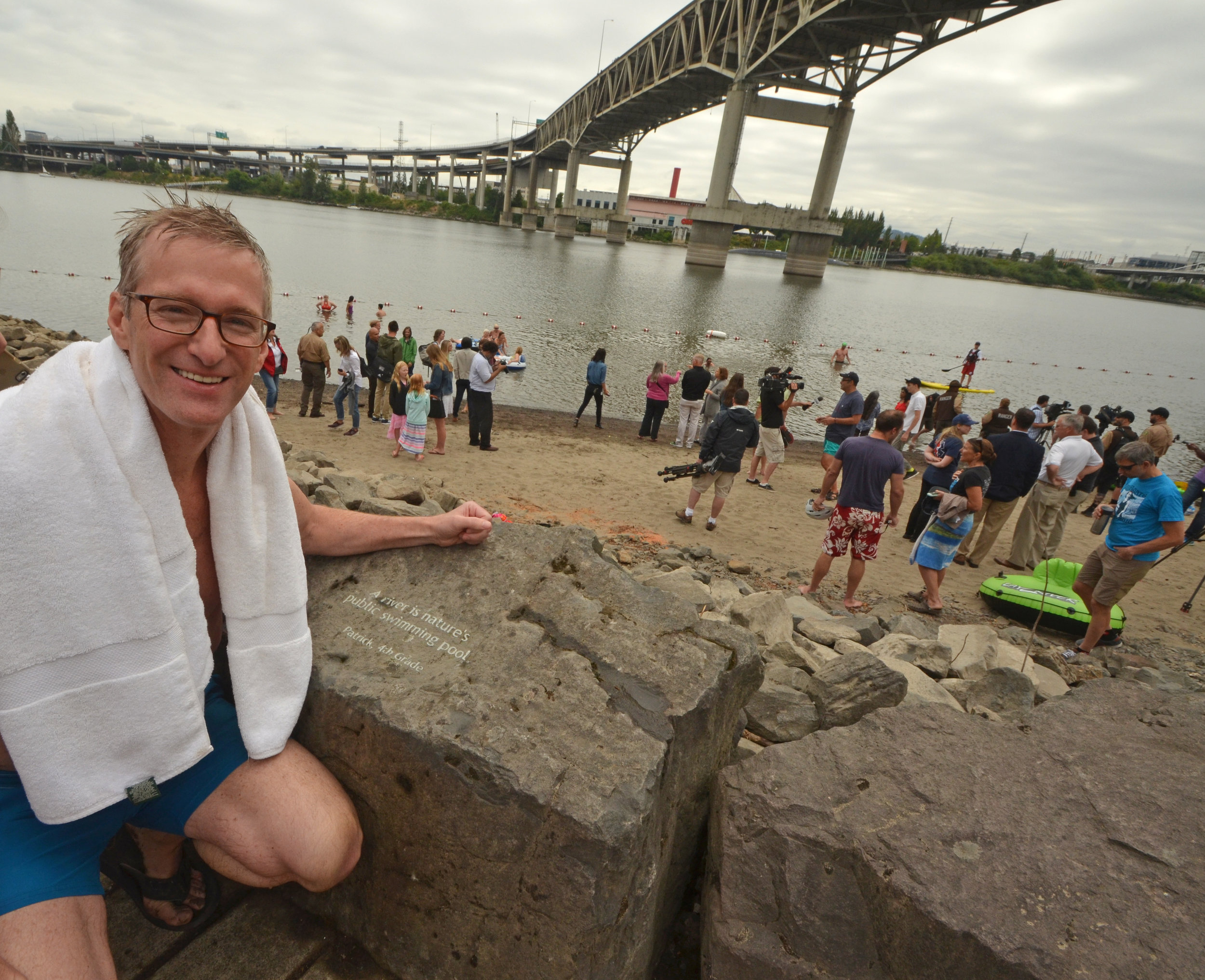  Mayor Ted Wheeler beside Honoring Our Rivers student poem at Poet's Beach. 