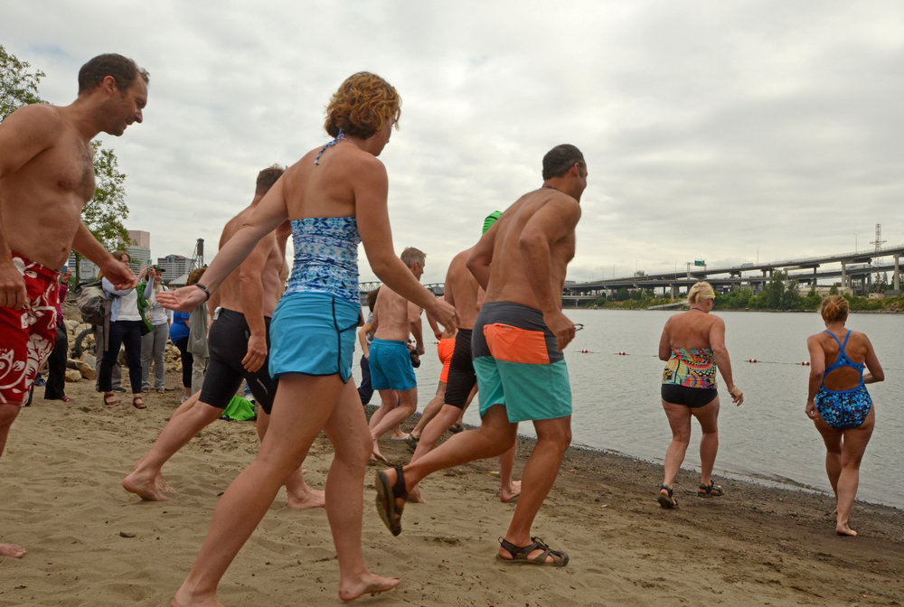  Folks run into the Willametter River for a swim at Poet's Beach's First Splash event July 13, 2017. 