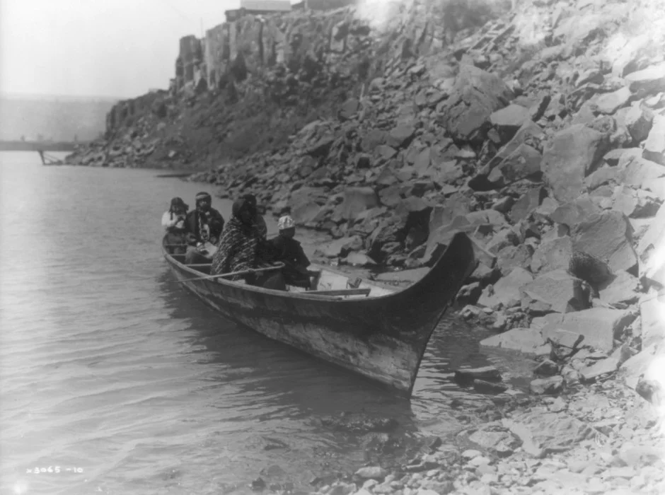 "Several Wishram Indians travel along the Columbia River in a raised-prow, Chinook-style canoe in this undated photo." LIBRARY OF CONGRESS, #3A47171U / OPB