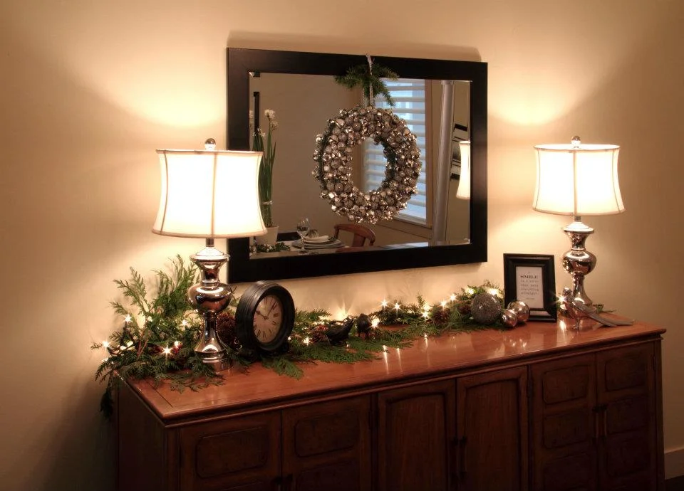 Fresh greenery, paired with a warm mini-lights and silver and black accents gave this home a refined Christmas glow.