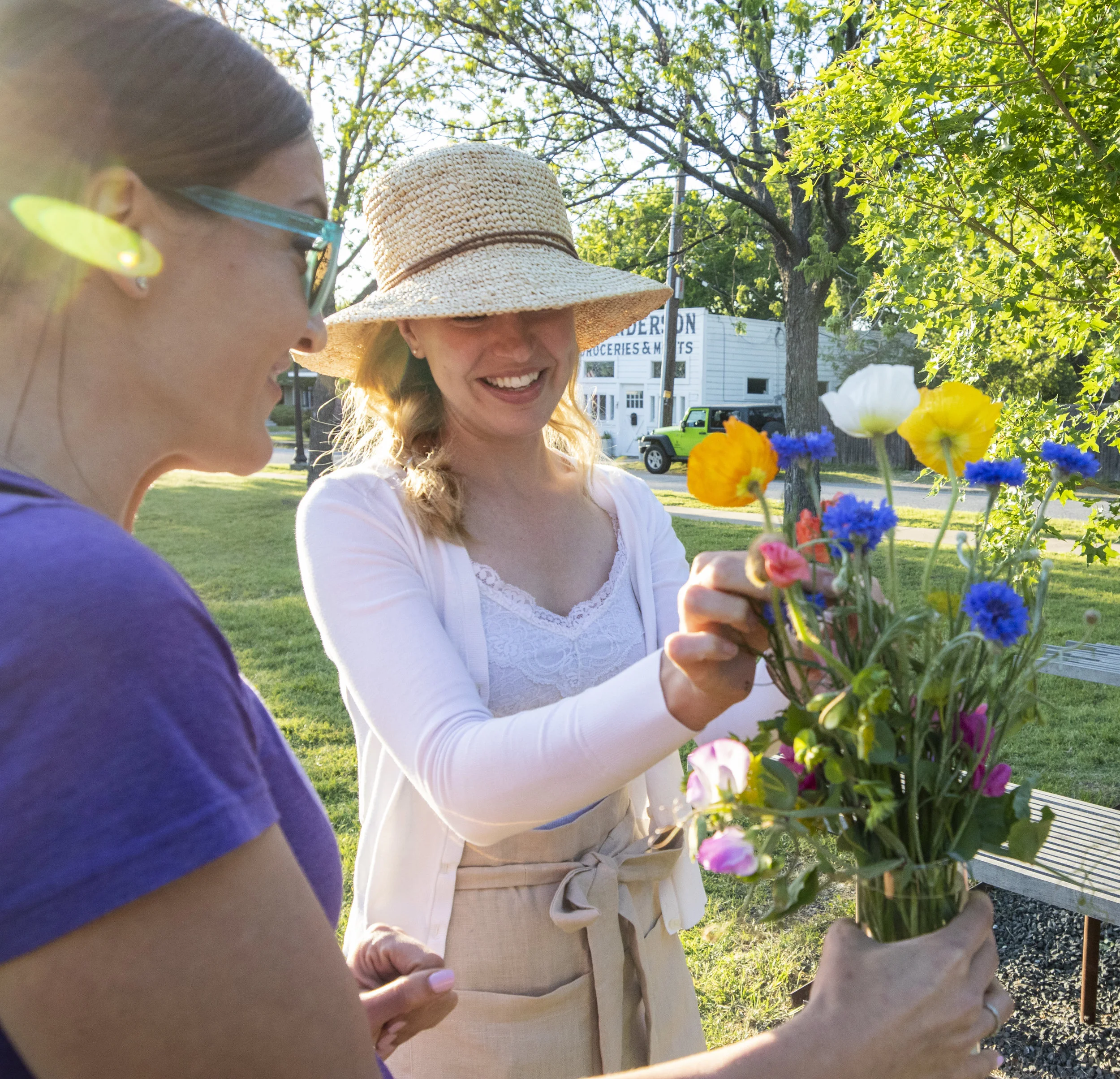  After Toon’s arranging demonstration, she compliments customers on their style.  Photo by Sam Bruton  