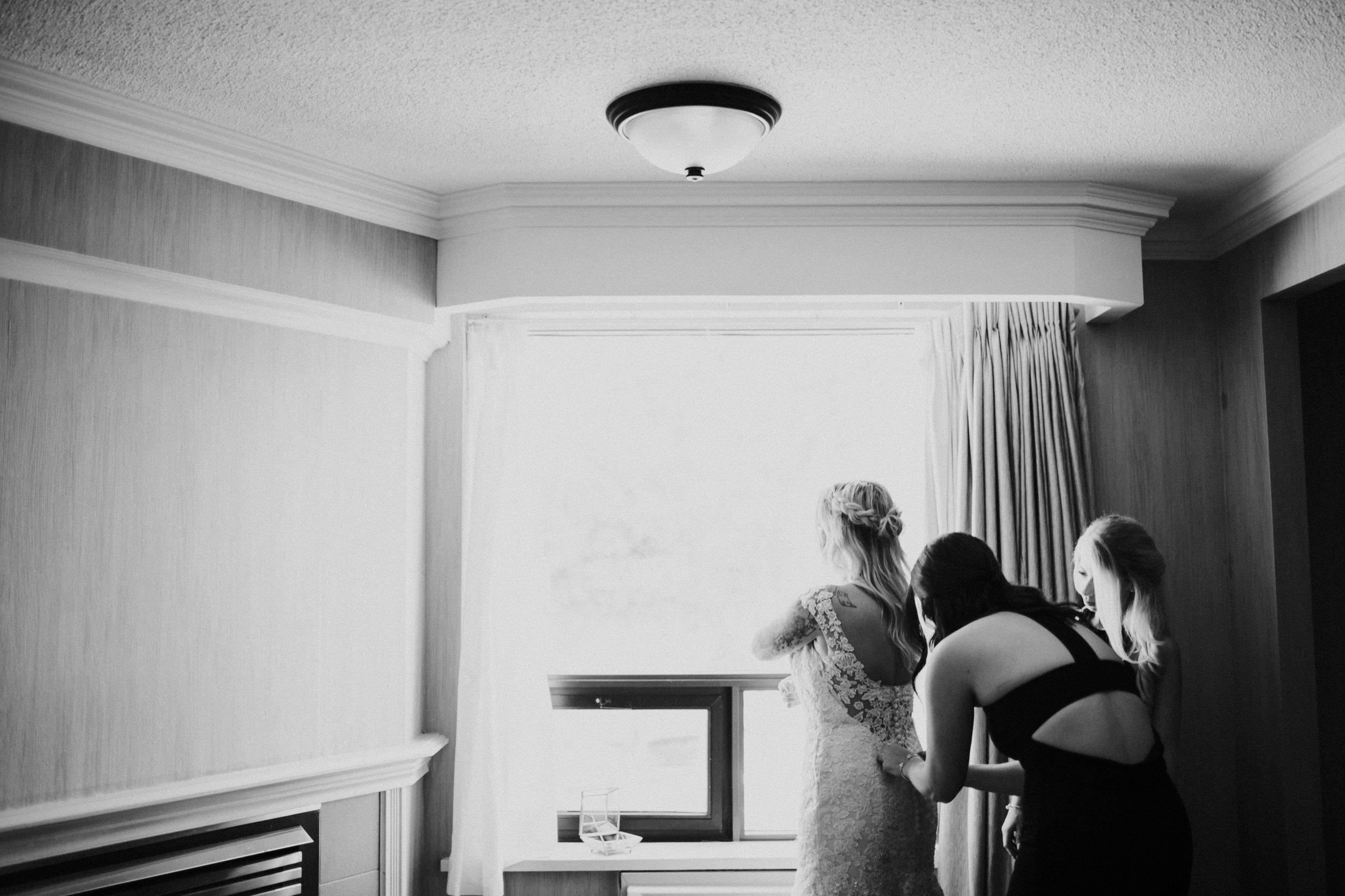 bride getting into wedding dress in Midland wedding 