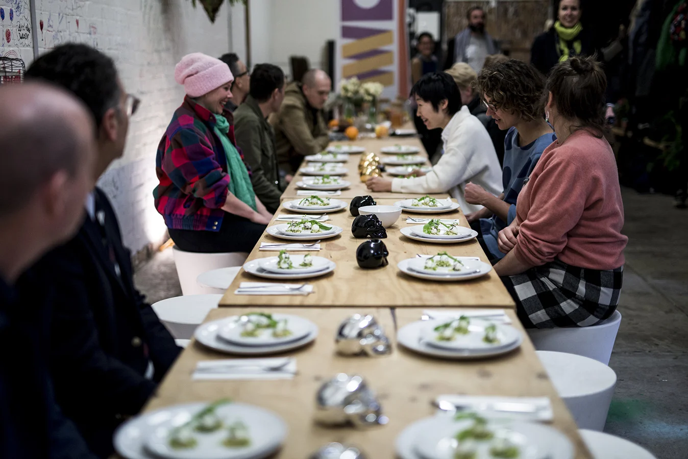 Biennial Lab artists and guests sit down to eat their meal, guided by Chef Peter Gunn. Photo: Pheobe Powell.