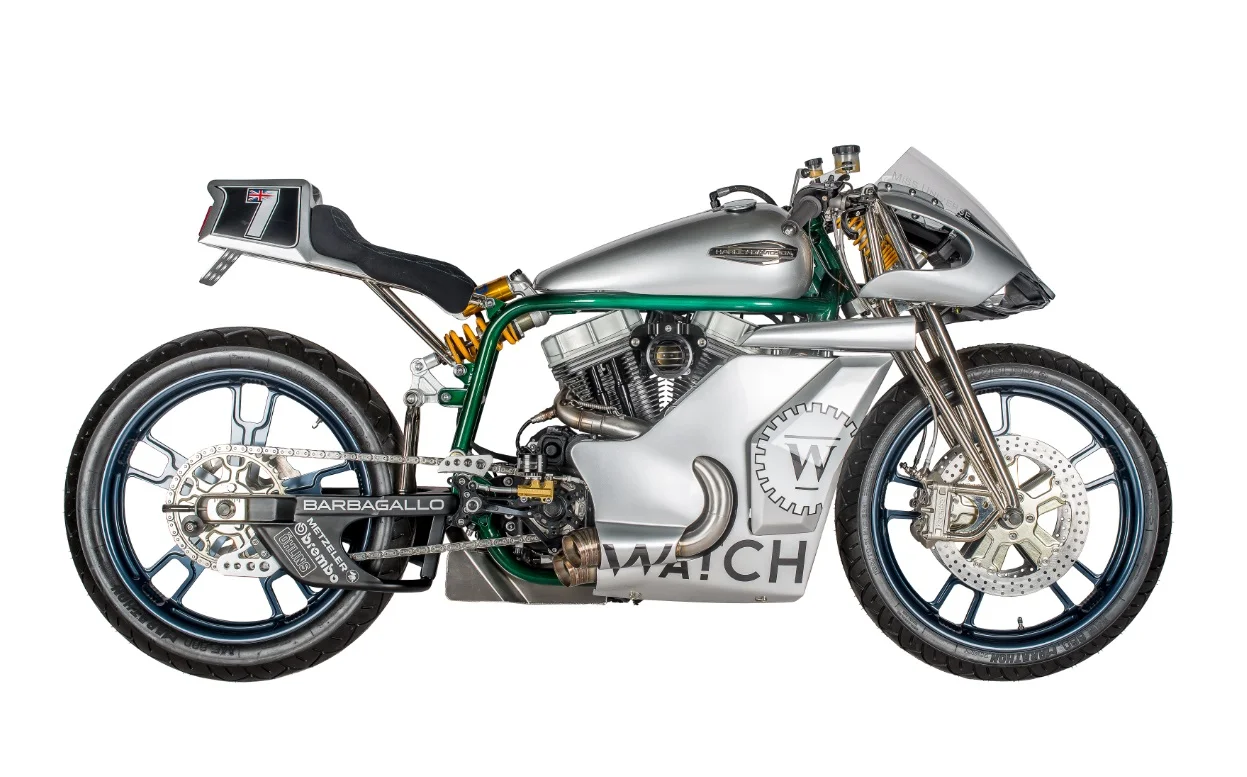 Based on a Sportster 48, this cafe racer was commissioned by Australian businessman Troy Barbagallo after seeing Shaw’s . New perimeter frame allows a low-mounted custom gas tank, with dummy front end for wiring, battery, and ignition coil. Custom swingarm has monoshock suspension (that looks reminiscent of the 1970s Godier Genoud Kawasaki endurance racers) and Öhlins shock. Custom parallel-link girders were built by a MotoGP technician. Front discs are 13in rotors, with twin six-pot Performance Machine calipers. </p>