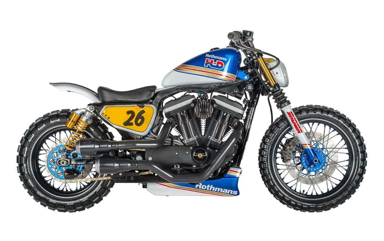 The Rothmans Scrambler is yet another example of how the Sportster works as a platform for so many styles. The only limitation is the builder’s vision. The client for the Rothmans Sportster was inspired by the Martini twins that the Speed Shop previously built. The 1970s motorsport-themed bike features: RSD bars, risers, levers and derby cover; Shaw Speed provided the timing cover; wheels are by Shaw Speed too. It’s got a final drive chain conversion, forks are Harley but shocks are Ohlins. Tank is stock Harley with Rough Craft gas cap, air breather is also by Rough Craft and paint is by Image Design Custom.