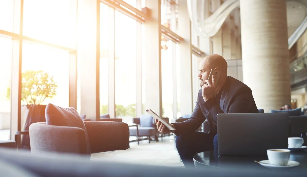 shutterstock_399953872 Serious Business Man at Airport Conference Call_small_Web.jpg