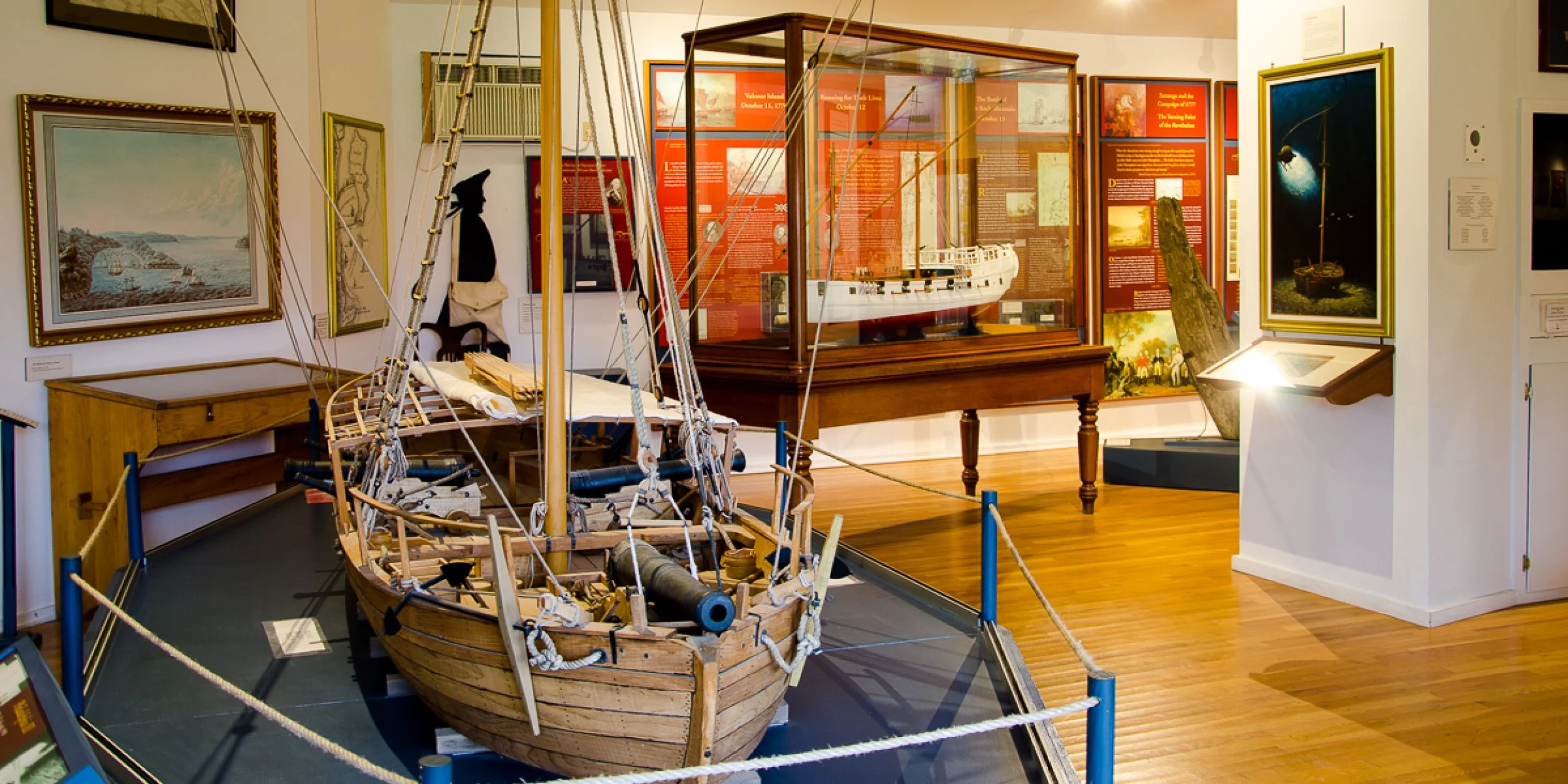 Lake Champlain Maritime Museum in Vergennes, Vermont with replica boats and lakeside exhibits.