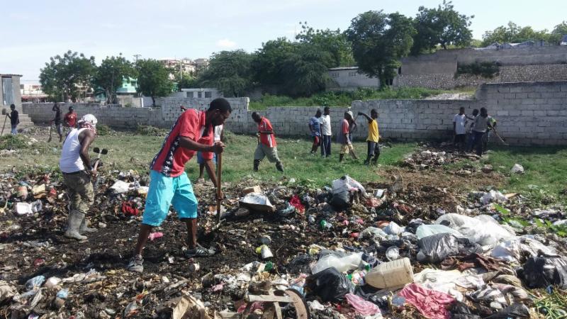 CLEAN UP - community members join together fulfill their dream of a soccer field.