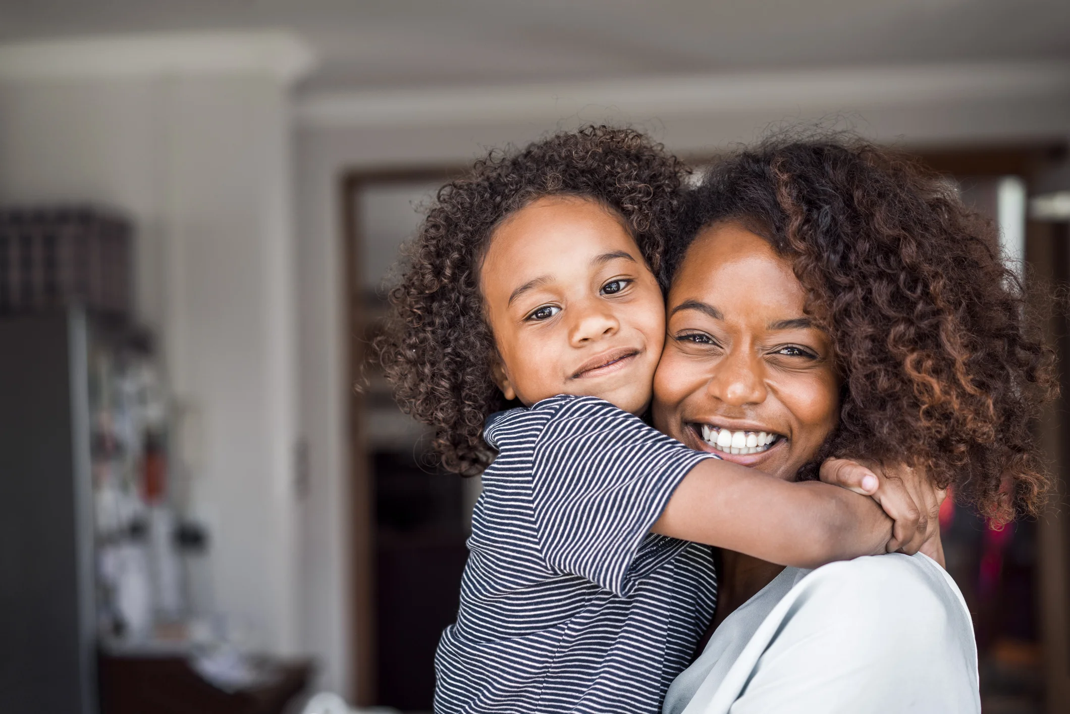 Happy-mother-and-daughter-embracing-at-home-516034730_2123x1416.jpeg