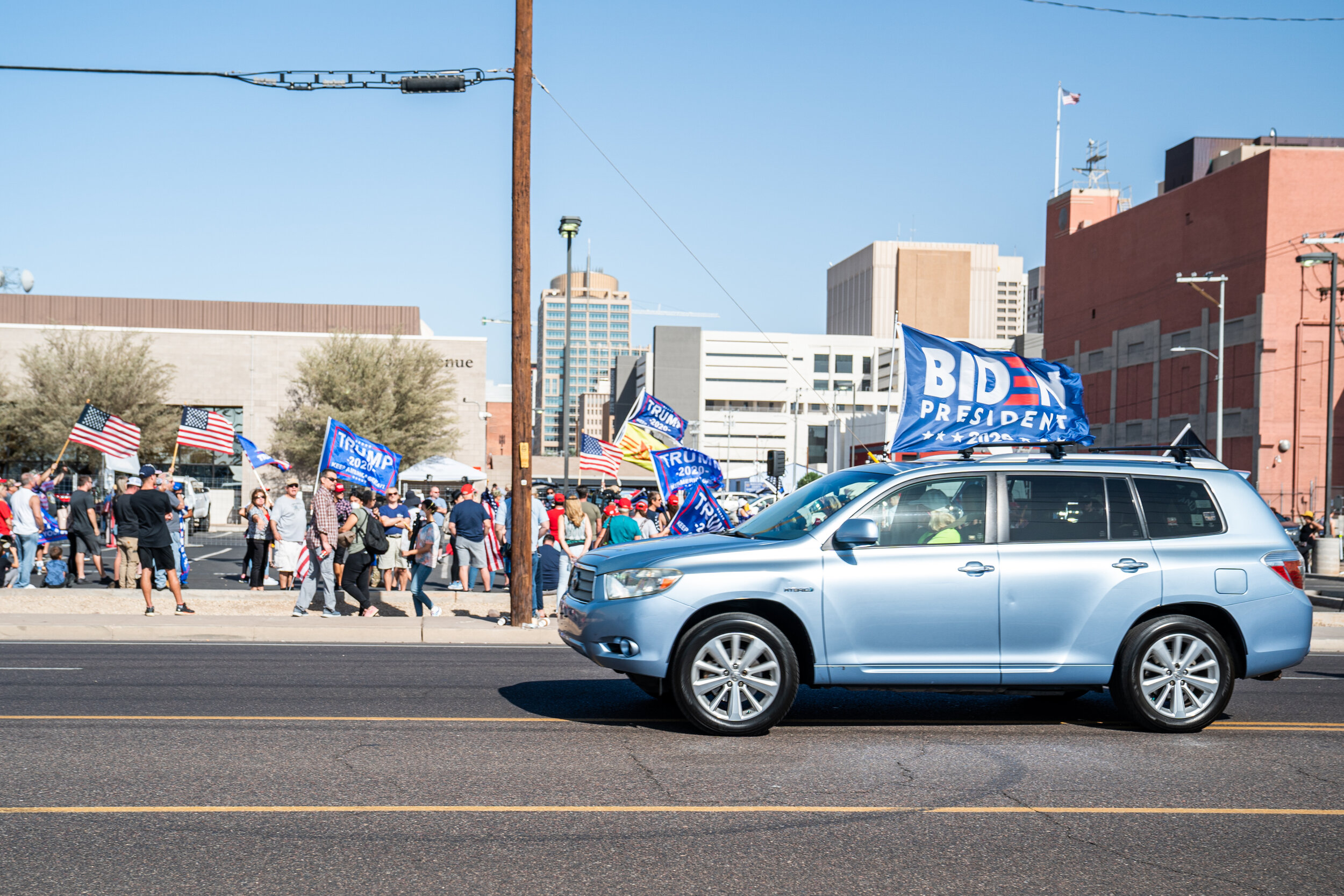 On the morning that AP called the presidential election for Joe Biden, his supporters drive past a group of Trump supporters in front of the Maricopa County Elections Center in Phoenix, Arizona. 