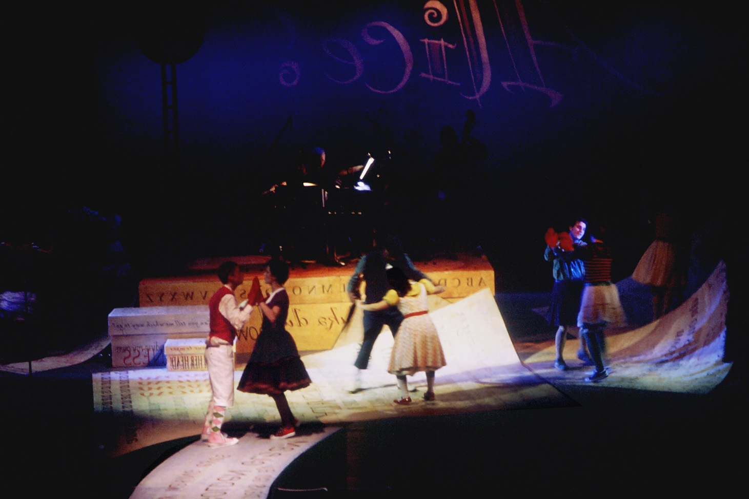 All of the fallen papers and boxes were structural, and the actors danced and skated on them. Trap doors in the set, including the river into the audience, and the scrim upstage enabled them to pop up anywhere in the set.
