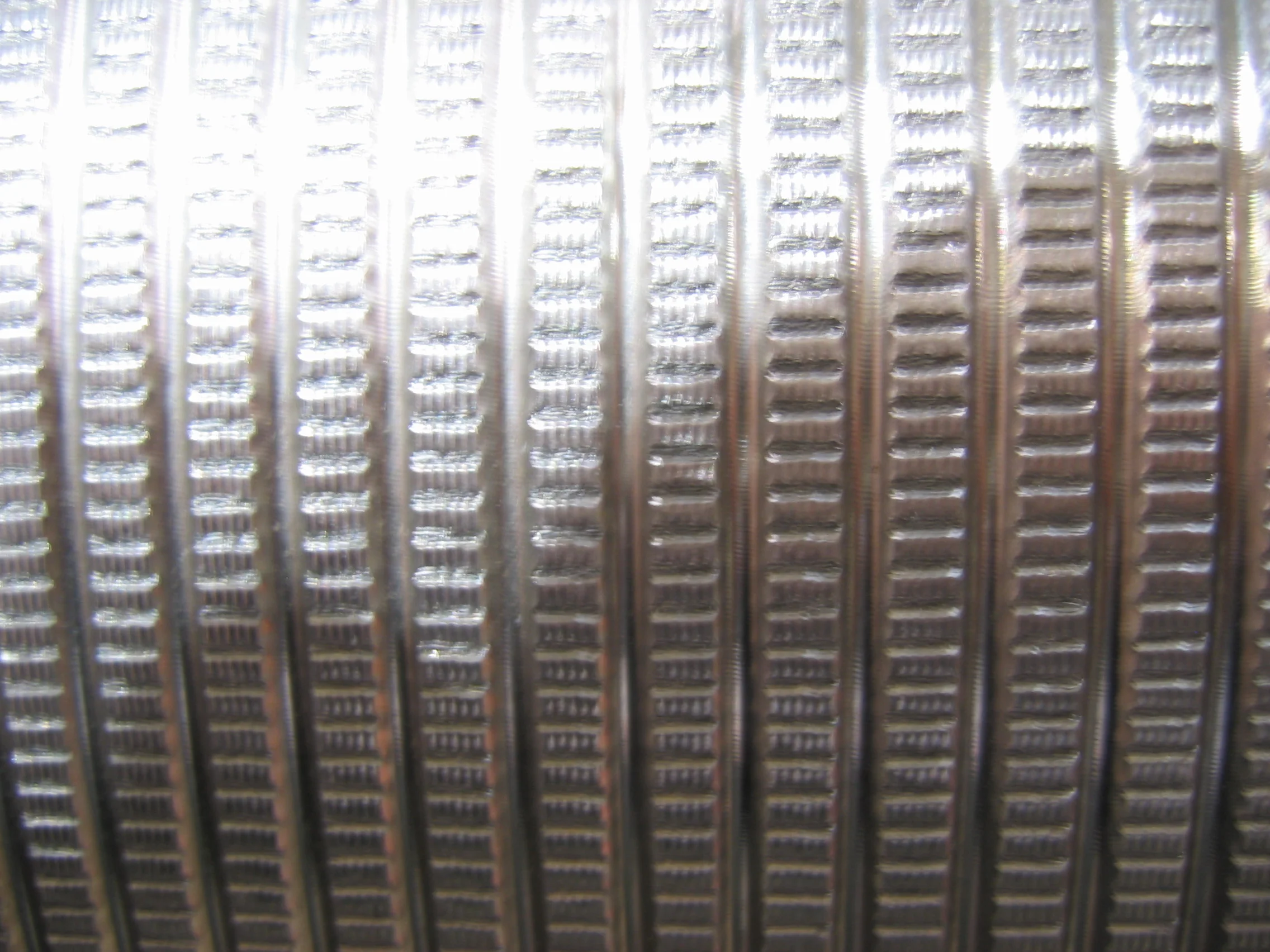 Close up of a fine pitch knurl on a roll.