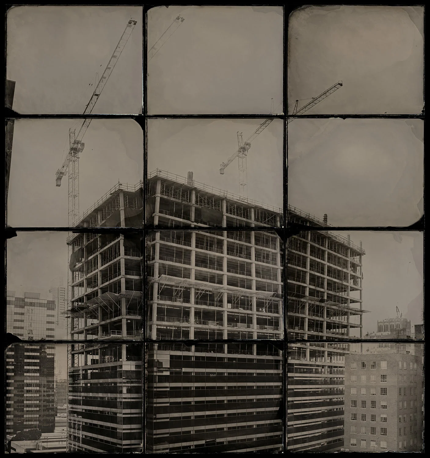 Windows - By: Matthew Magruder www.matthewmagruder.com I stumbled through making my first tintype in 2008 and have been pretty active in the process ever since. Alternative process photography has been a mainstay for me since about 2002. This 12-plate image is a part of a much bigger body of work. The series is titled “Windows” (clever, I know, heh). The series is of downtown cityscapes of Austin, TX where I live. The series was not particularly motivated by any conscious philosophical drive/meaning for me...but as I worked on it I did find that it connected with a part of me that–generally speaking–sees the world, people, etc. as being multifaceted with parts that are skewed and irregular but that make up a bigger and greater sum. The process of creating them is sometimes a day(s) long procedure depending on the size. Each of the pieces always has a row of level plates and then the proceeding vertical columns are done by simply tilting the camera up and/or down. I find that longer lenses work better for obvious reasons as they serve to compress the field of view. Pretty much the entire series was shot with 16in, 18”, and 30” Goerz Red Dot Artars on either 8x10 or 11x14.