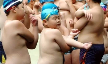 Chinese children warm up before swimming during a weight-reduction summer camp. Photo: Imaginechina/Corbis