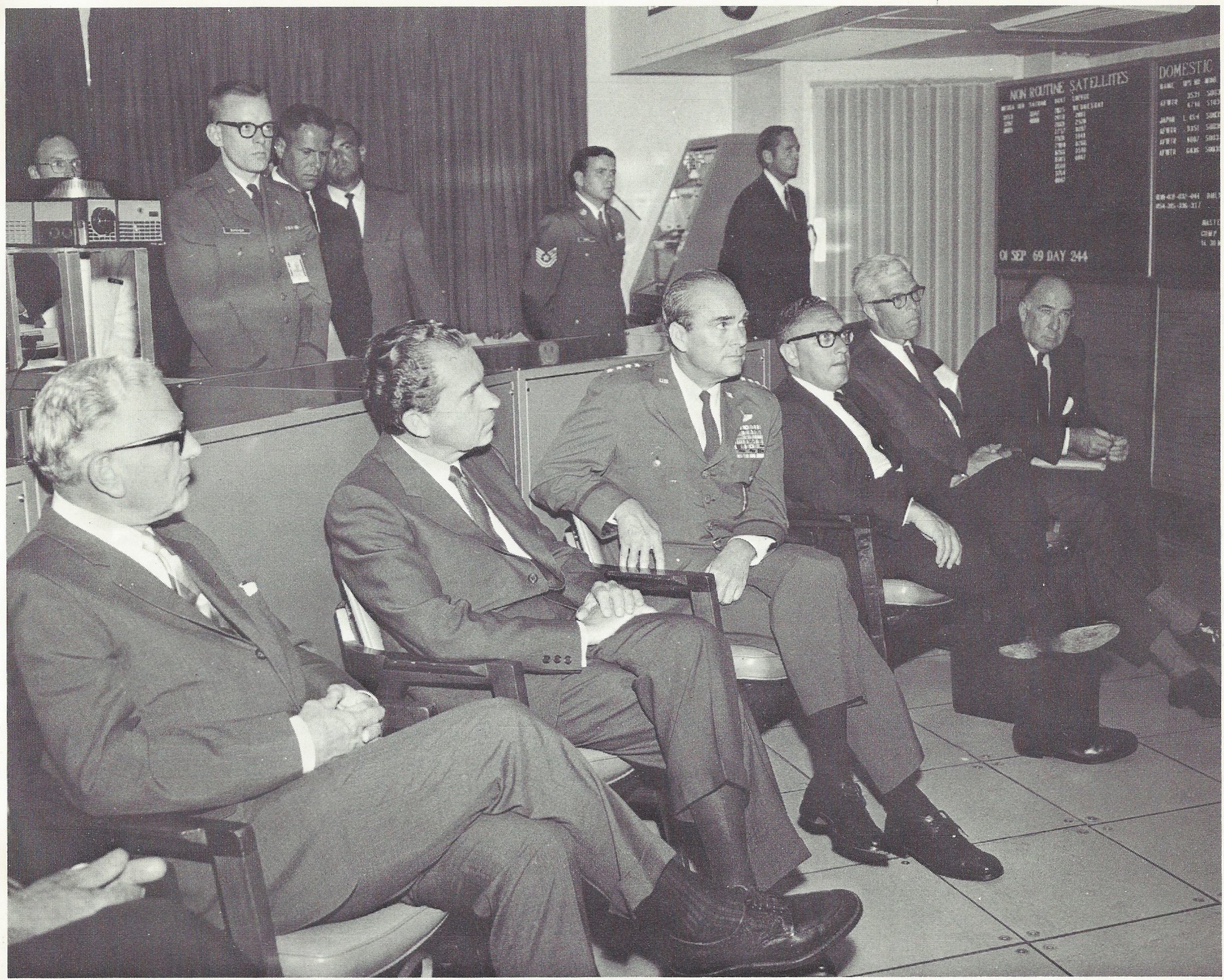  Caption: "DISTINGUISHED VISITORS - Richard M. Nixon is September 1969 became the first U.S. President to visit the underground command post of the North American Air Defense Command. He is shown here in NORAD's Space Defense Center being briefed by 
