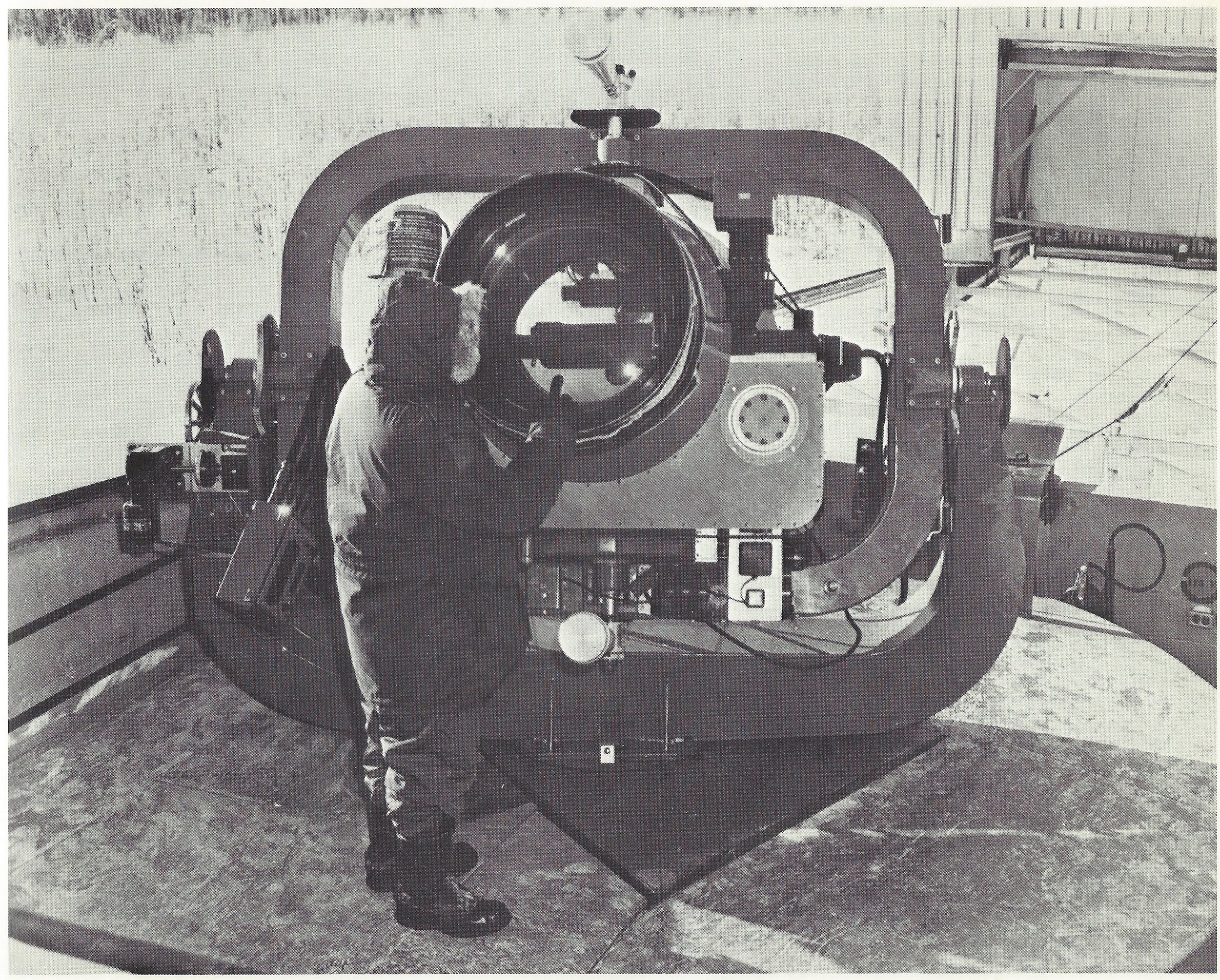  Caption: "SPACE BROWNIE - The most sensitive and precise satellite-tracking instrument in NORAD's satellite detection and tracking network is the Baker-Nunn camera, shown here. It can photograph light reflected from an object the size of a basketbal