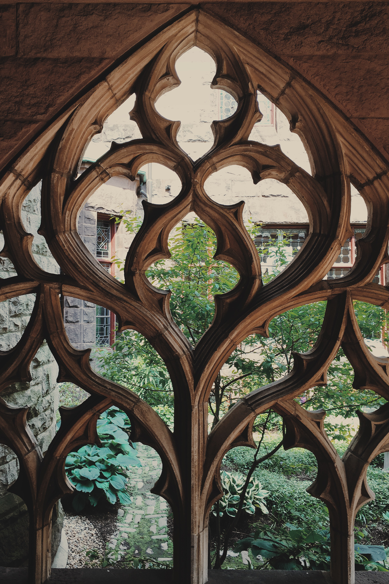 A garden full of new spring growth sits within a courtyard of the rear entrance to the church. 