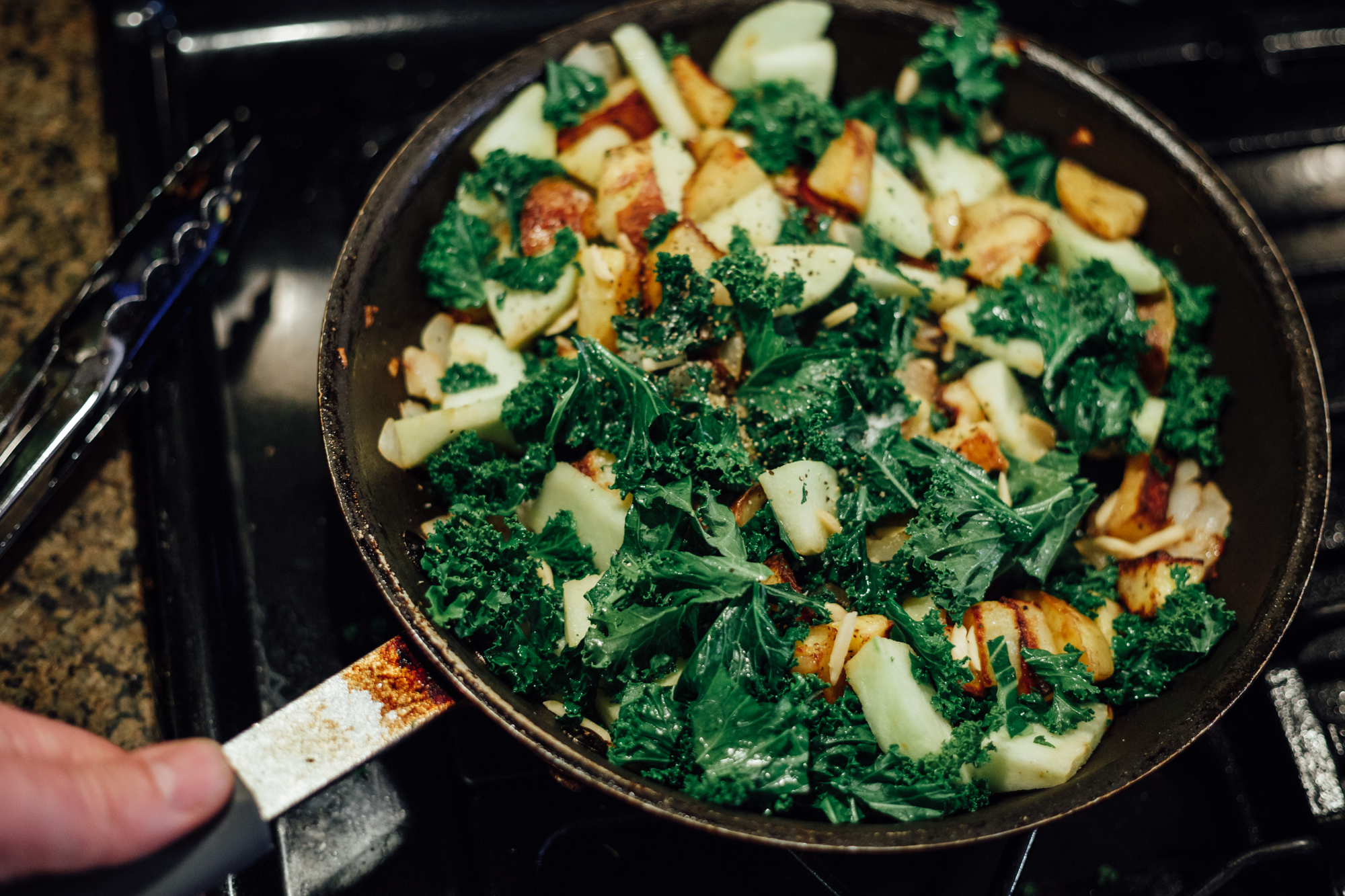 It's all coming together now! I love the combination of colors, textures and smells in this dish. Here I have potatoes, apples, onions, almonds and kale just about to be placed onto a dish, and will top them with a pice of seared chicken. 