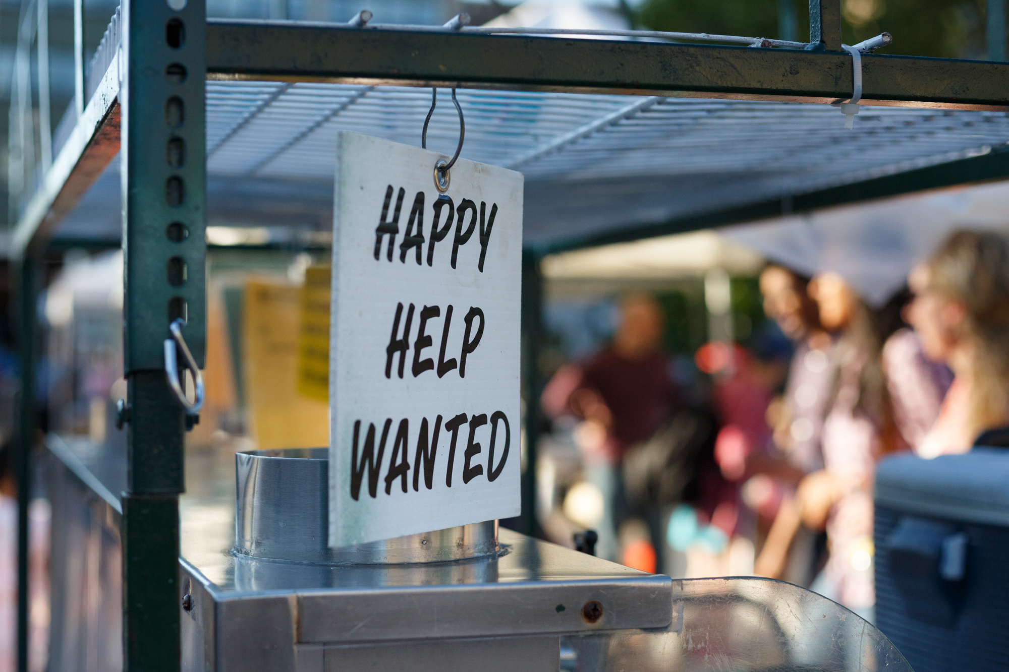 I loved the clarification of the sort of help needed on this sign hanging on an un-manned cart.