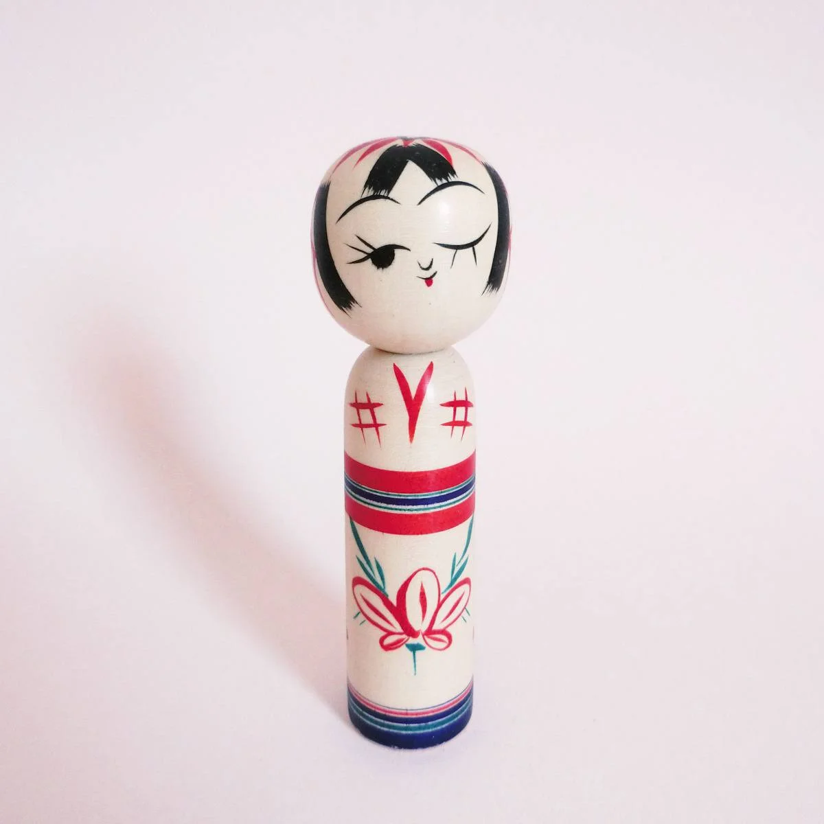 Wink kokeshi and peach flower by Kanou Hiroshi