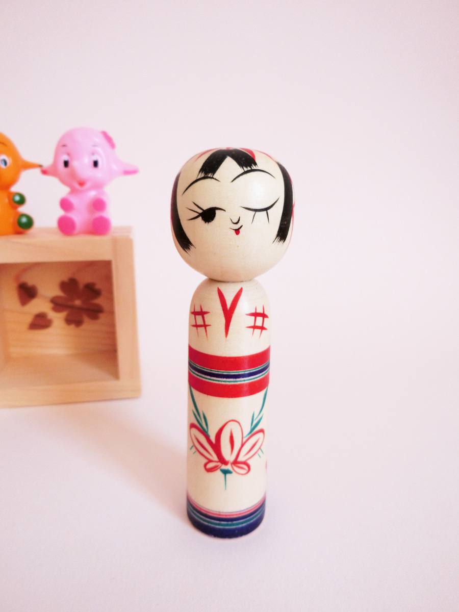 Wink kokeshi and peach flower by Kanou Hiroshi