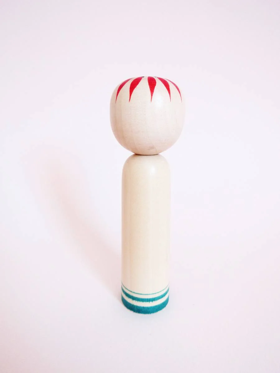 Sakunami kokeshi doll with plum blossom