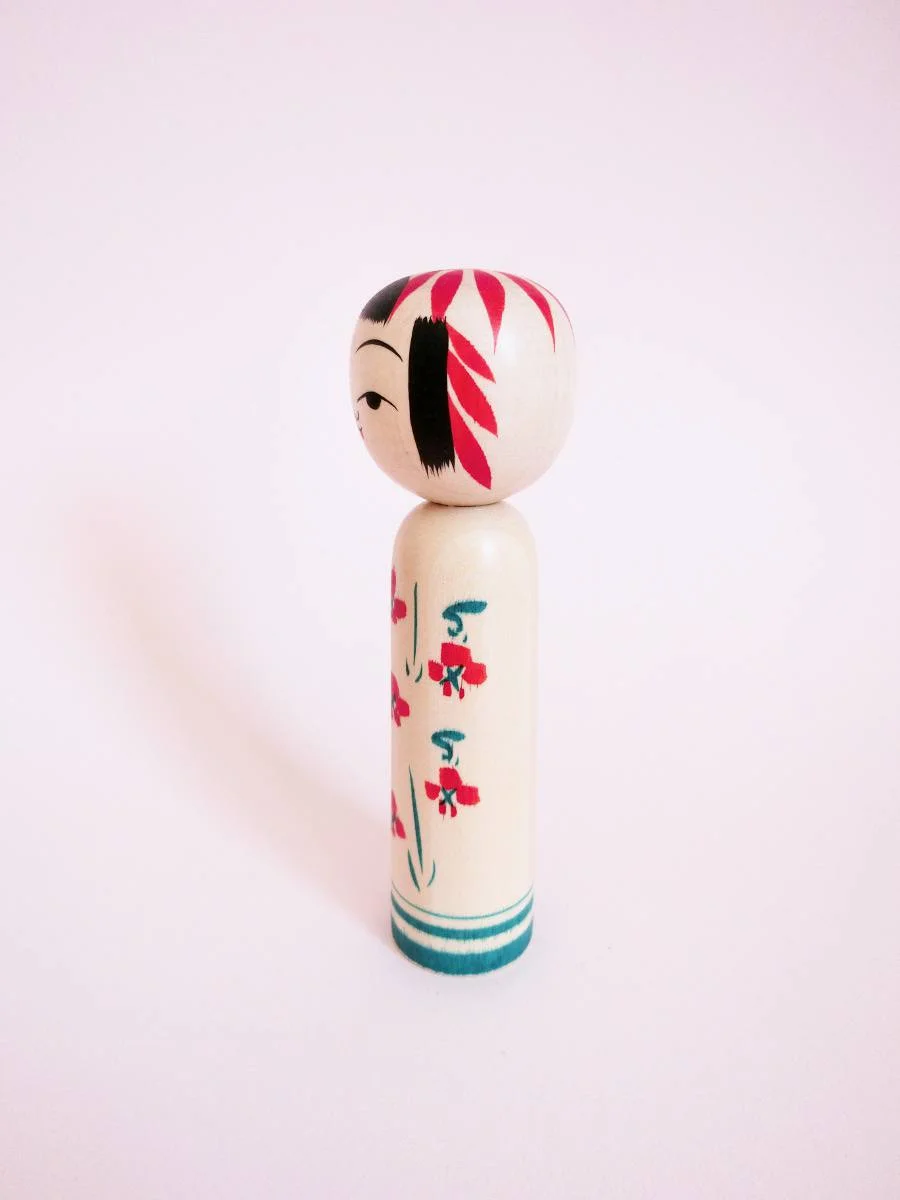Sakunami kokeshi doll with plum blossom