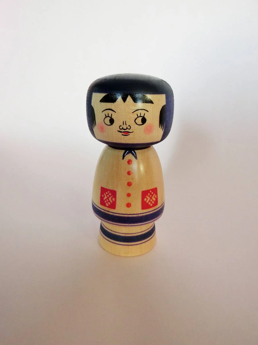 Purple kokeshi doll in creative style